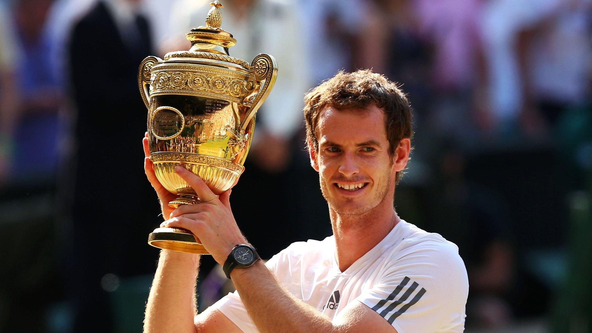 Andy Murray holds the Wimbledon trophy aloft