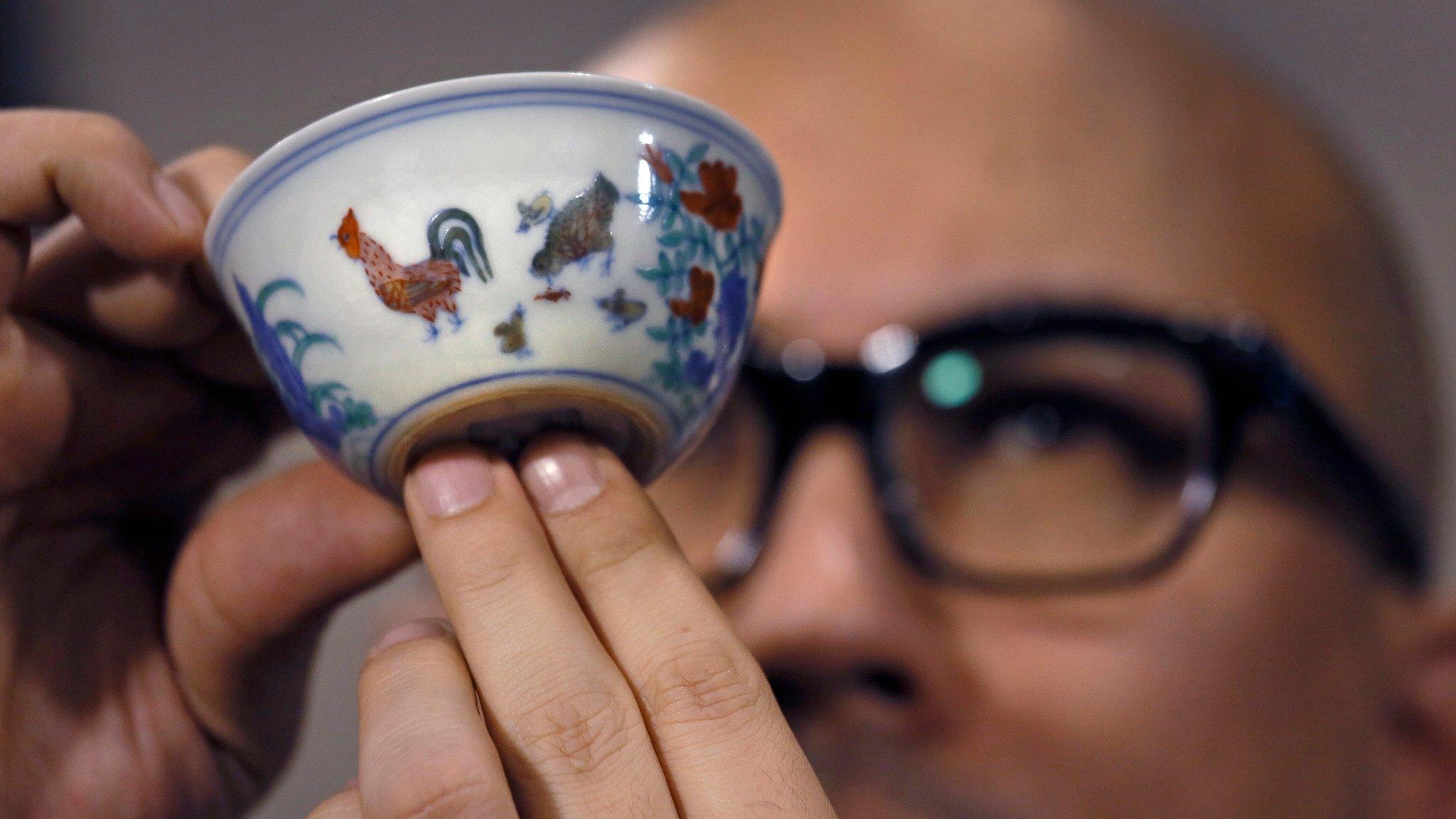 Sotheby’s deputy chairman for Asia, Nicholas Chow with the Meiyintang Chicken Cup