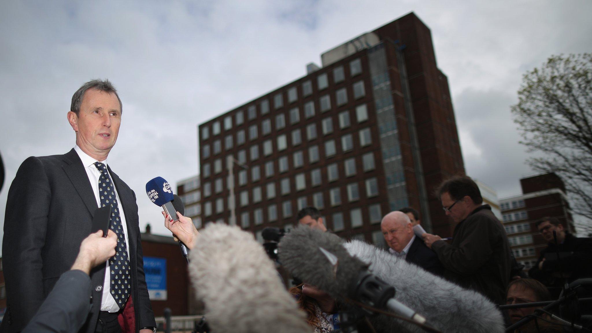 Nigel Evans surrounded by the press outside court