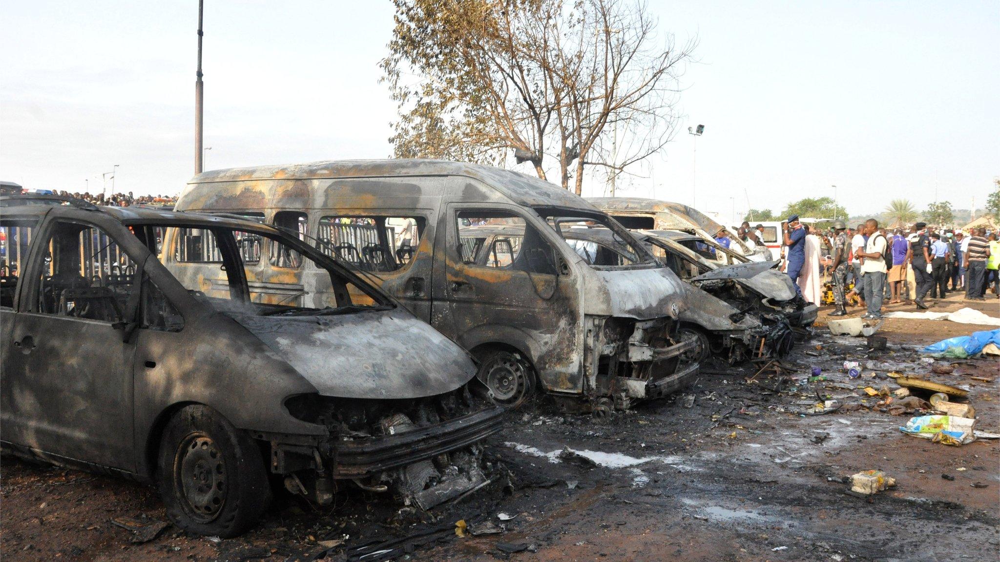 People gather at the site of the blast at the Nyanya Motor Park, 14 April