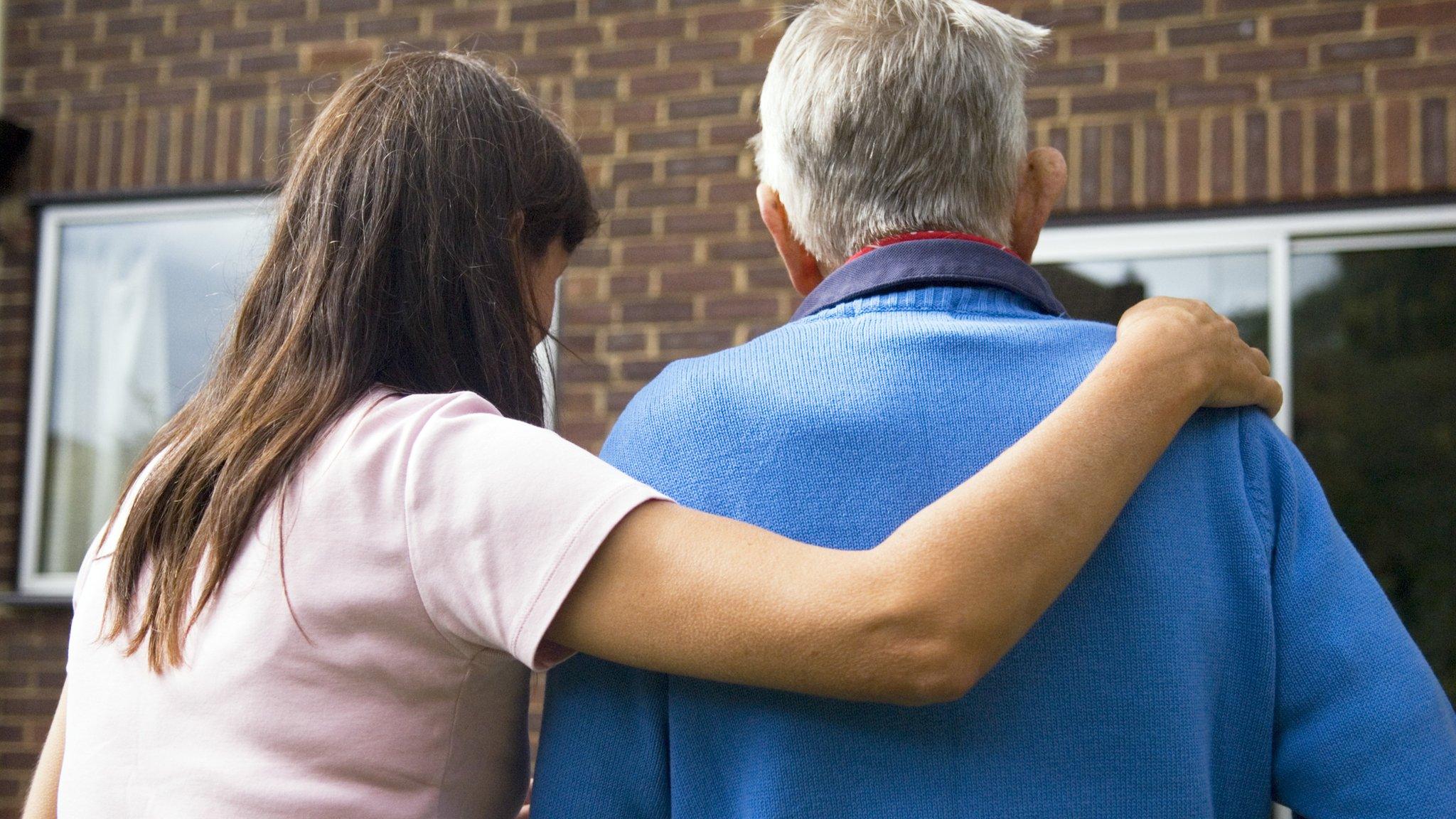 Woman helping elder person