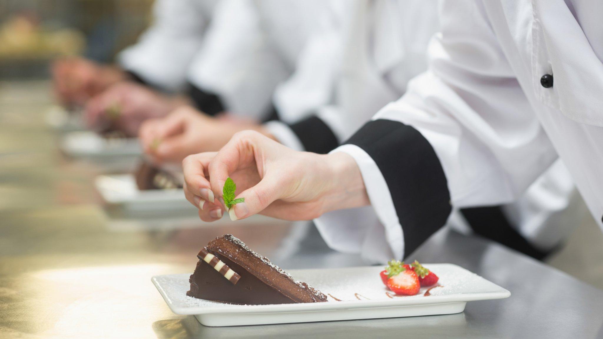 Workers garnish cakes