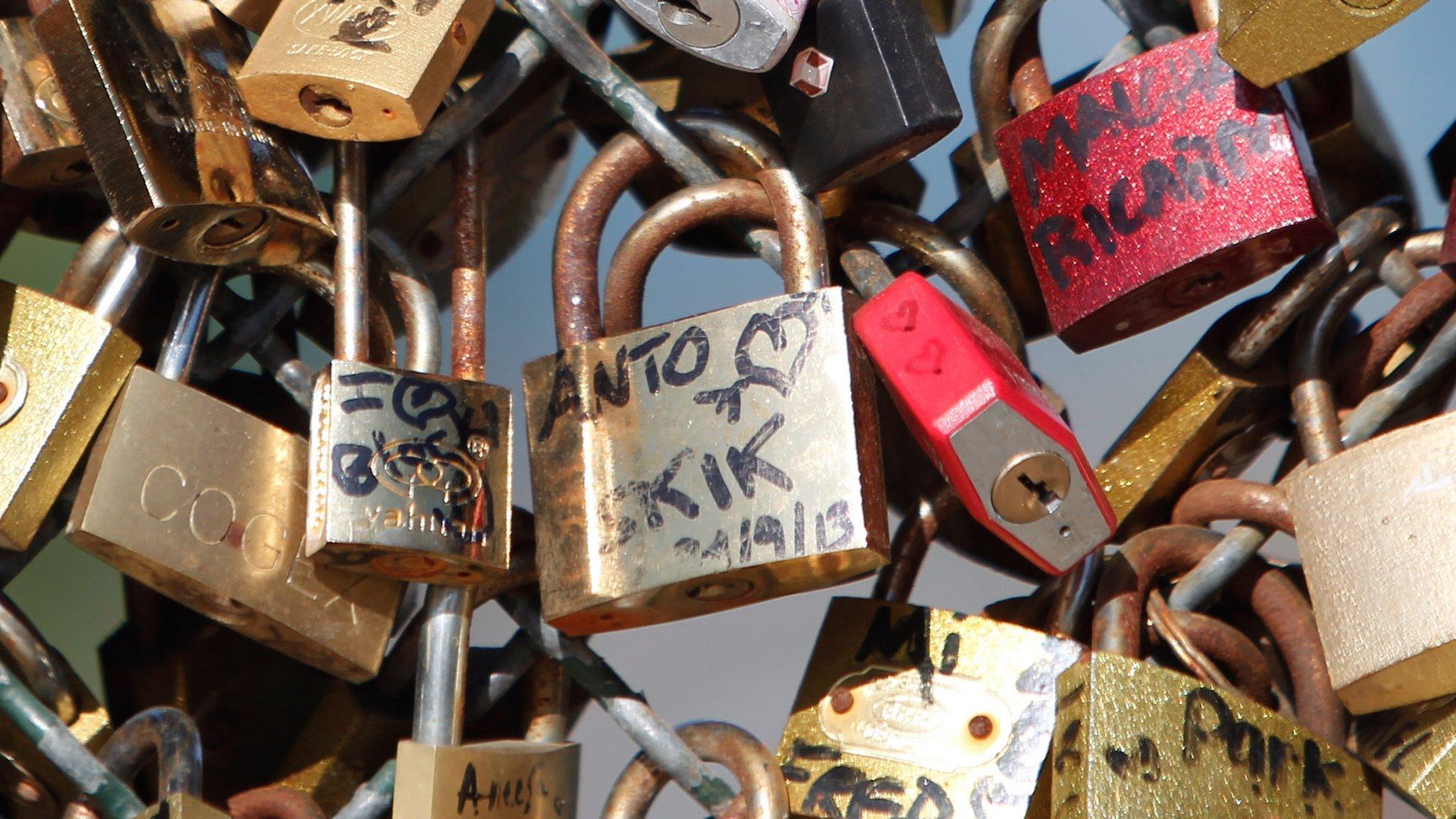 Love locks are fixed on the Pont des Arts in Paris