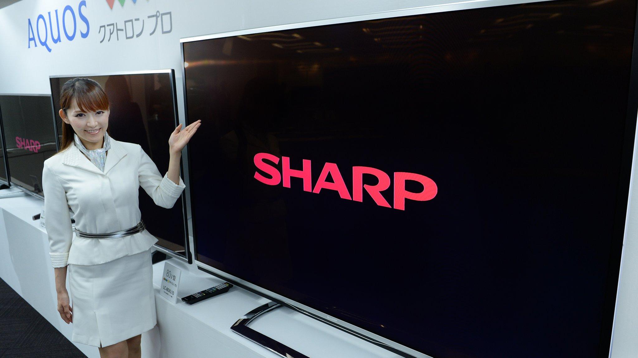 A model of Japan's electronics maker Sharp shows off new 4k liquid crystal display (LCD) TV