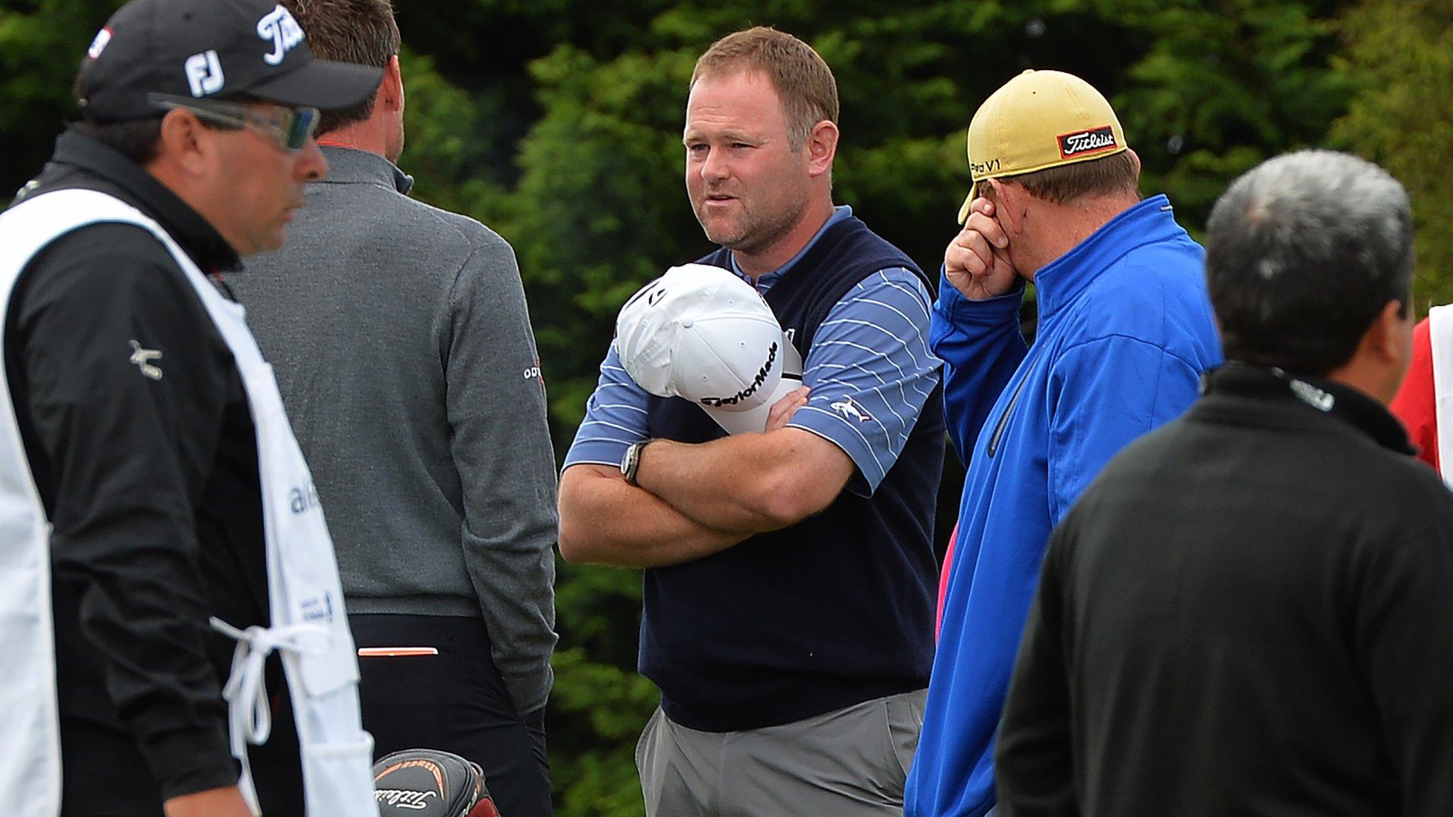 Alastair Forsyth talks to fellow golfers after the heart attack of his caddie Iain McGregor