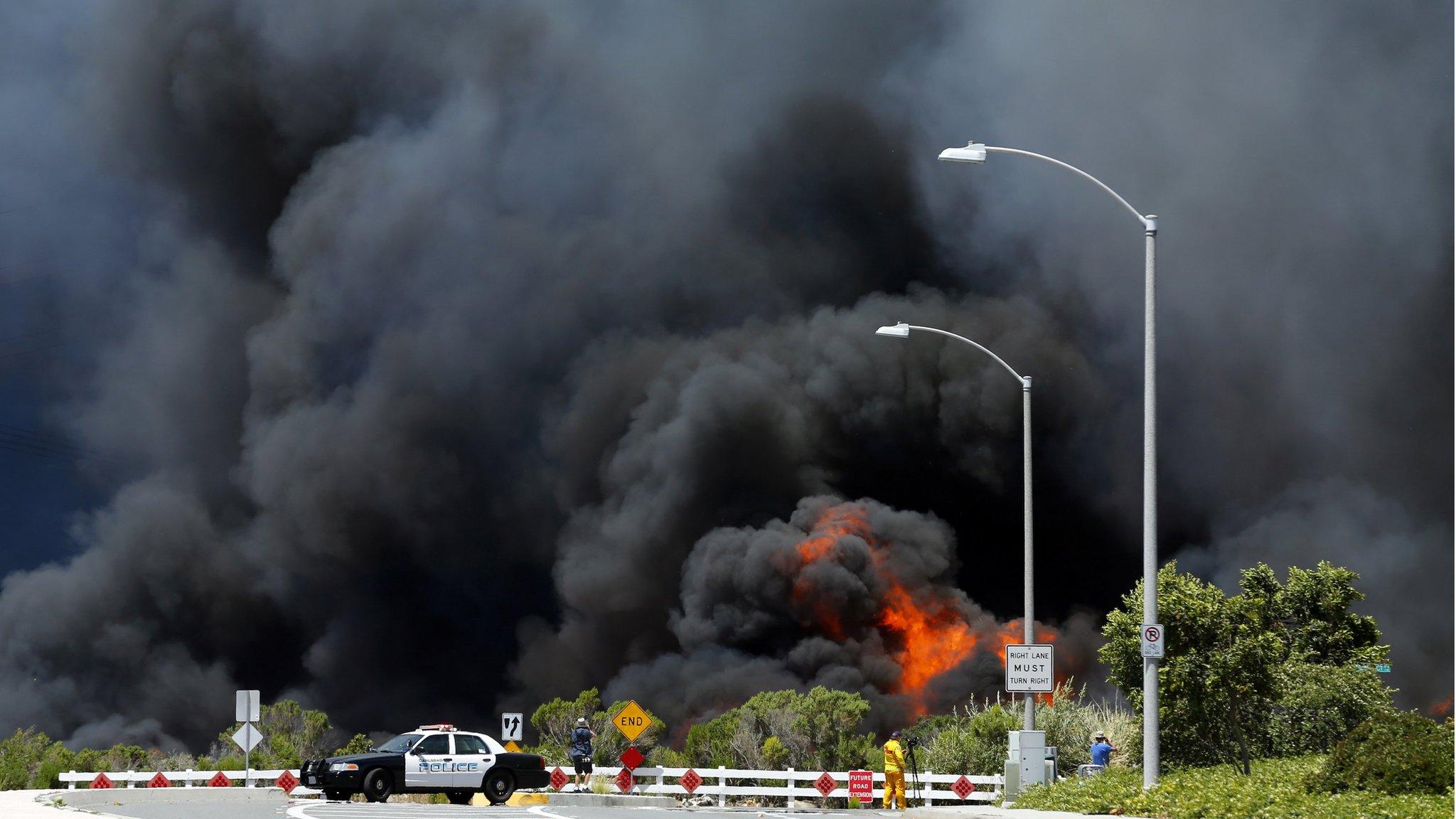 A wildfire burned through a canyon in Carlsbad, California, on 14 May 2014