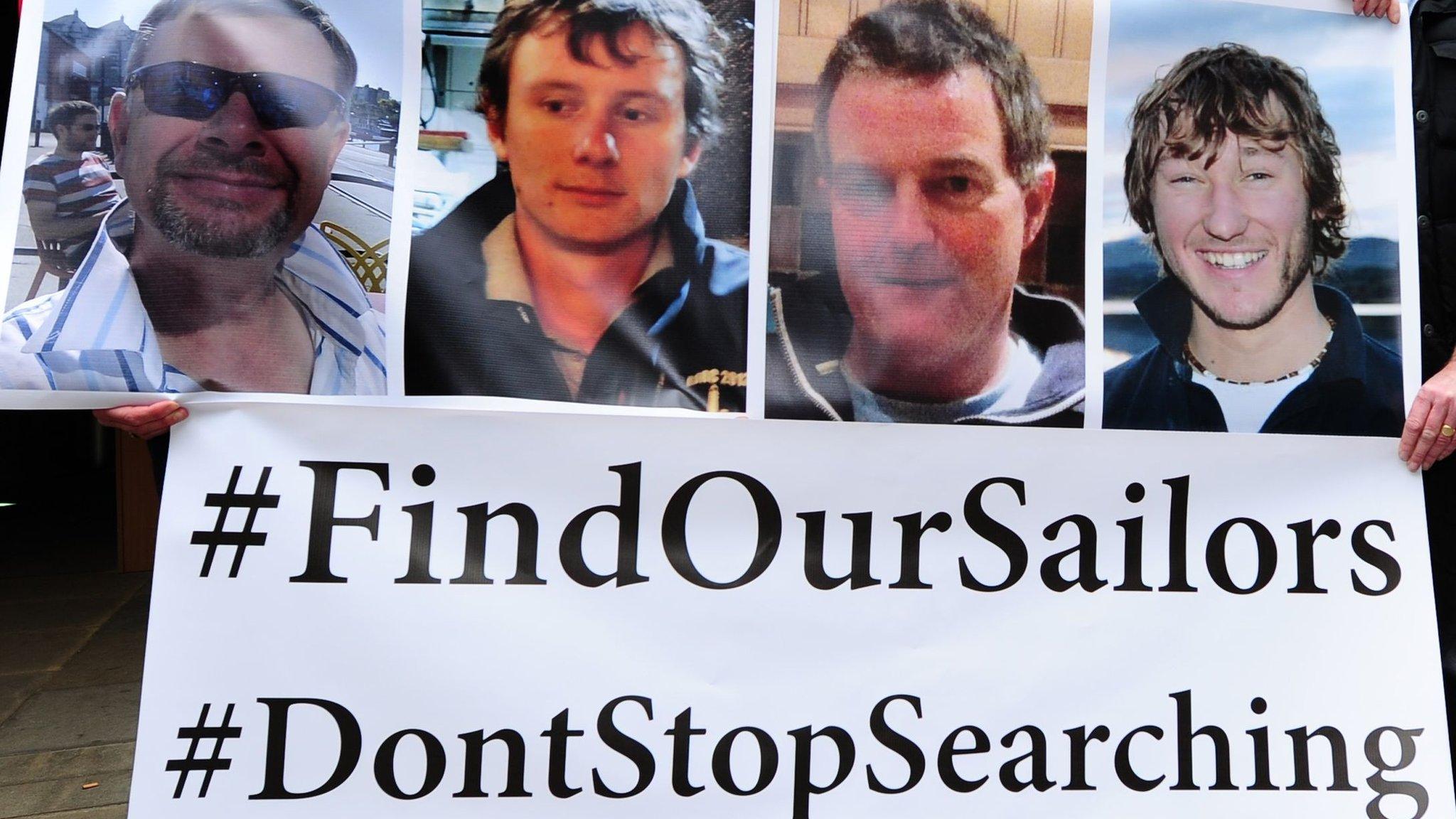 A banner with the men's faces and the text #FindOurSailors #DontStopSearching