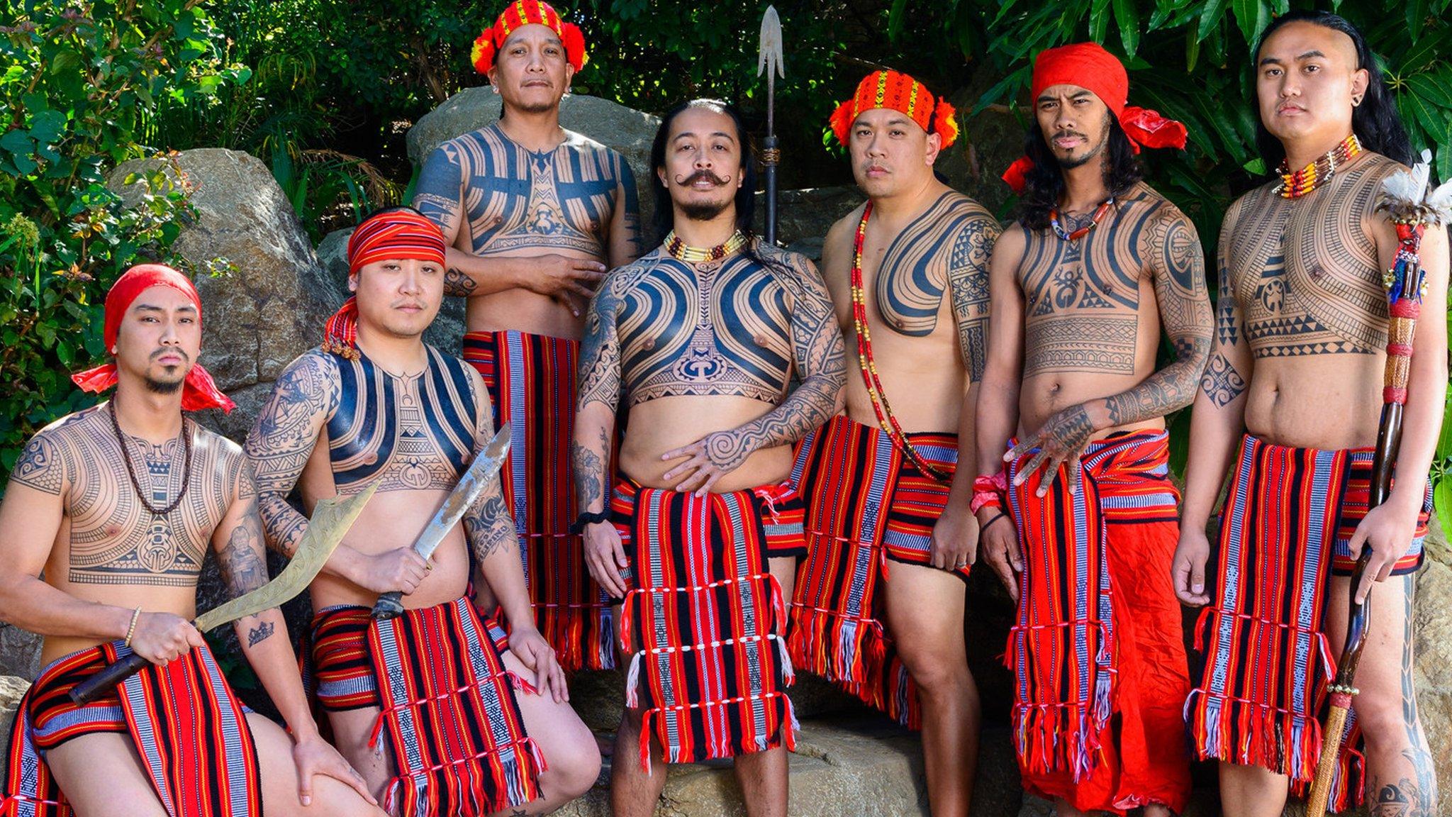 group of men with tribal tattoos