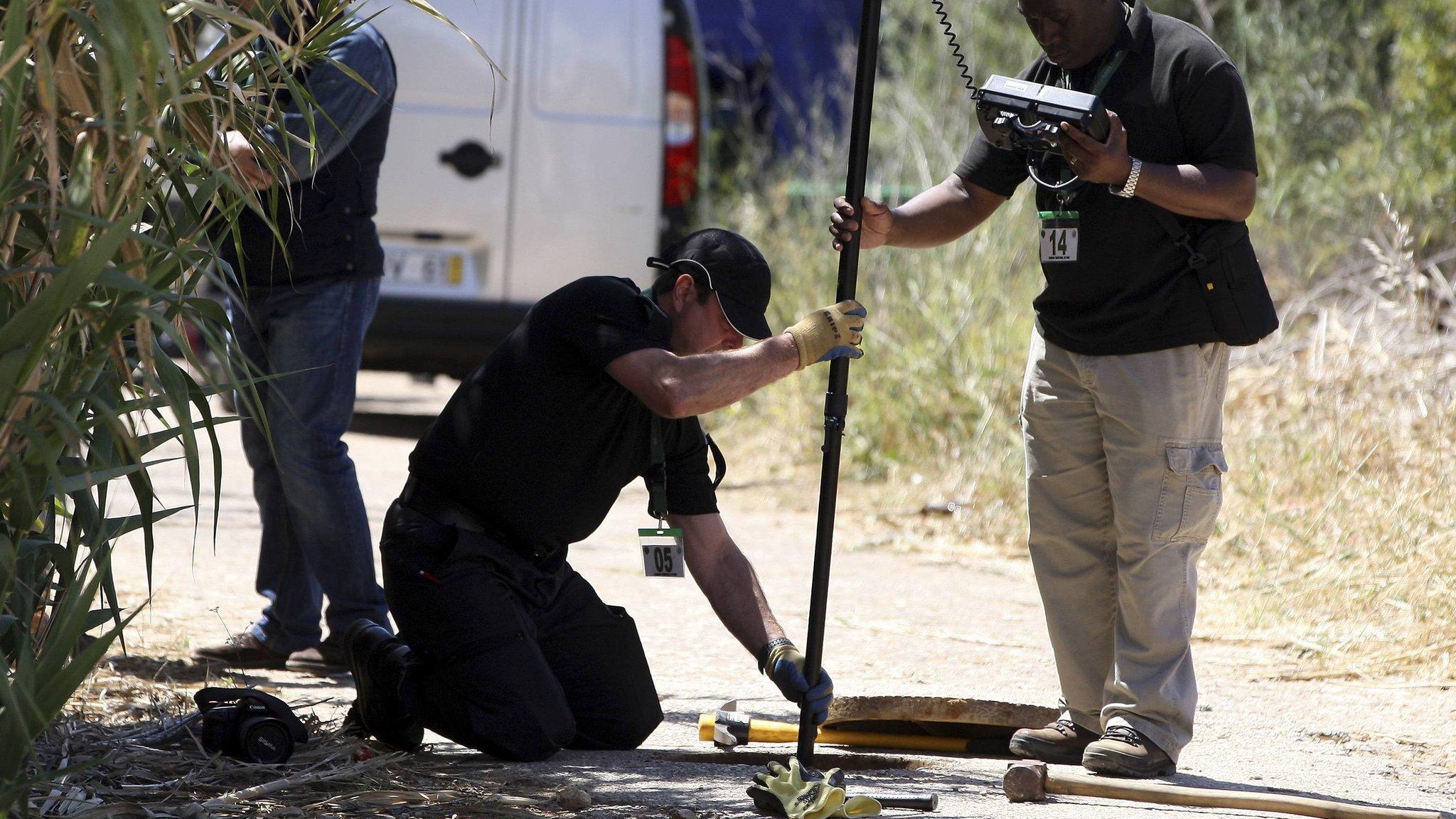 Members of Scotland Yard work during the search for missing British girl Madeleine McCann