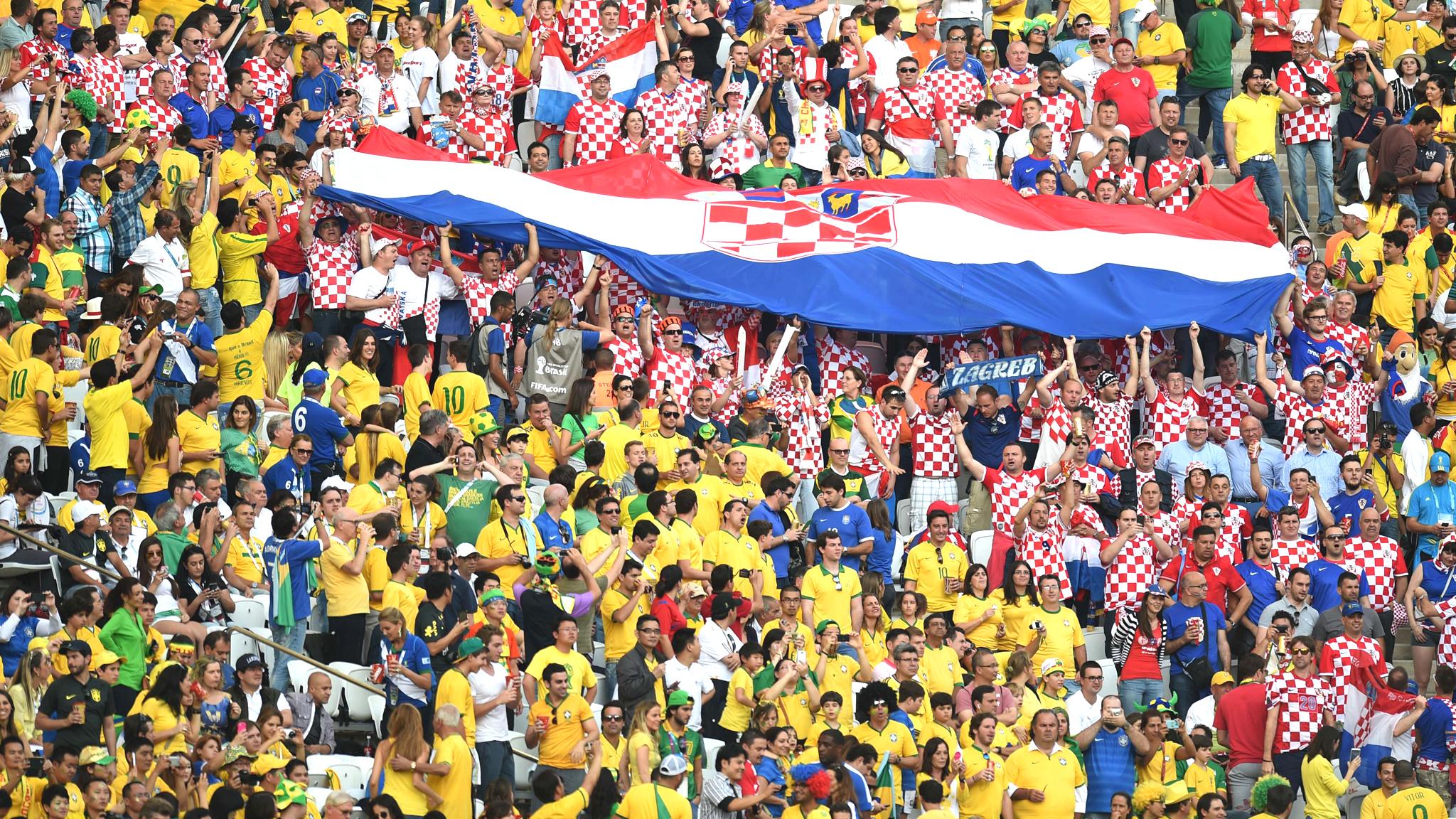 Brazil and Croatia fans greet their teams to the pitch