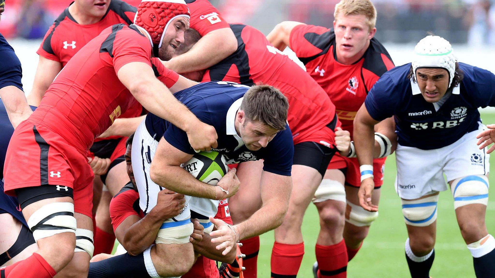 John Beattie is tackled by Jebb Sinclair