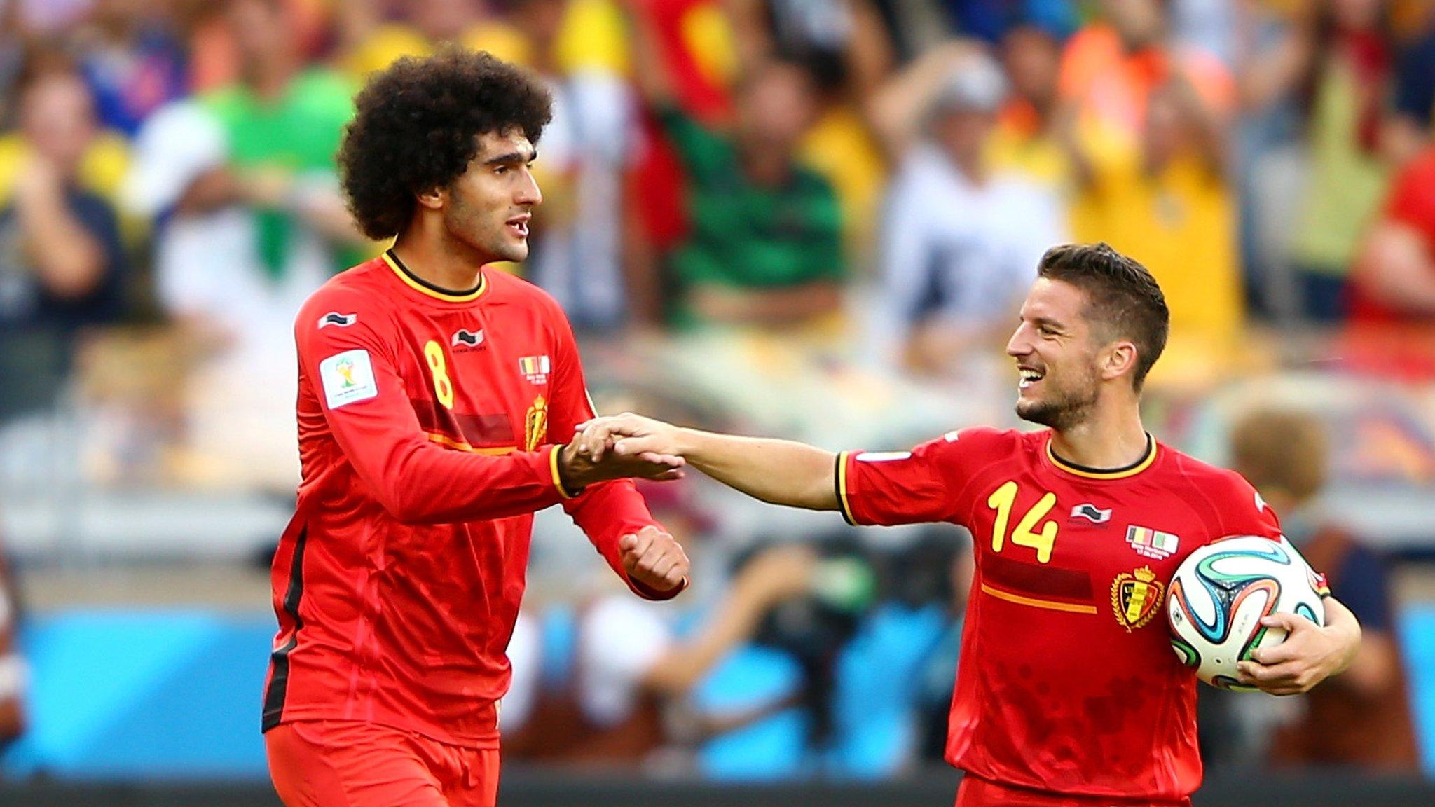 Marouanne Fellaini and Dries Mertens celebrate as Belgium beat Algeria 2-1 at the 2014 Fifa World Cup in Brazil .