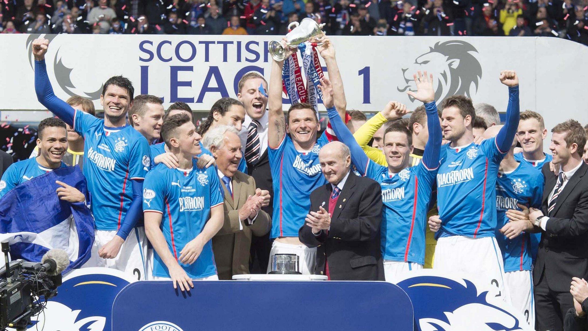 Rangers players celebrate with the Scottish League One trophy