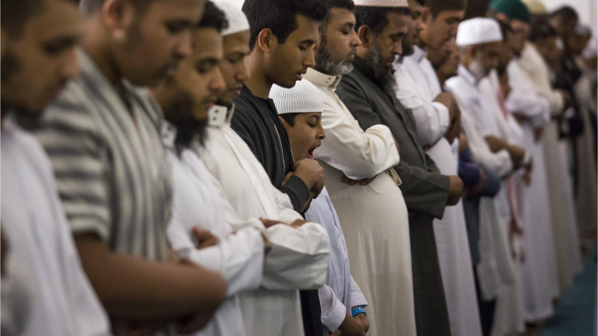 Men praying at East London mosque