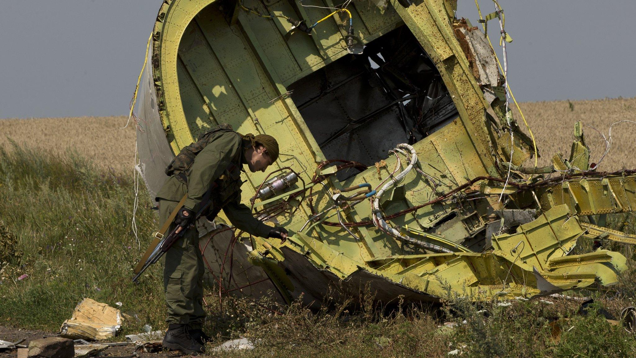 A rebel inspects the crash site