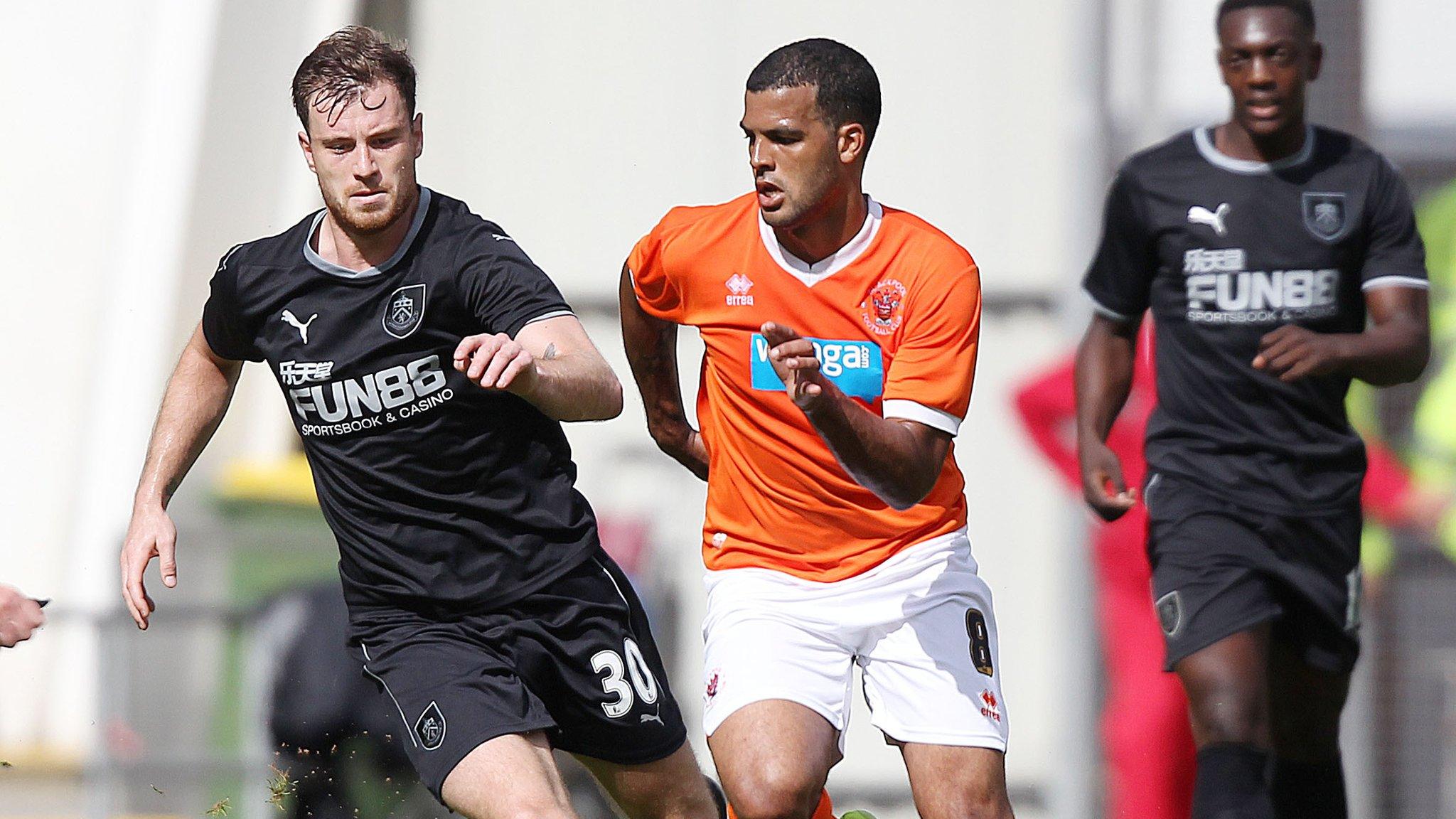 Blackpool's Jacob Mellis and Burnley's Ashley Barnes