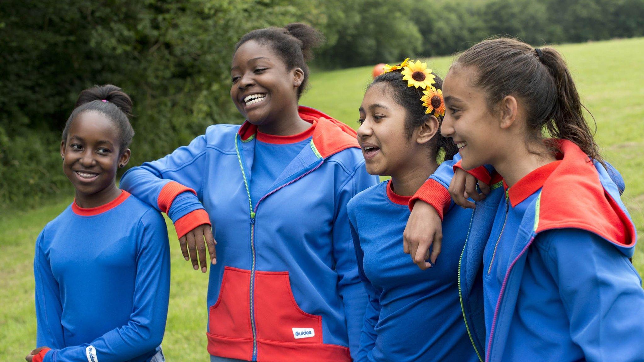 The new Girlguide uniform - blue tshirts and jumpers with red trim.