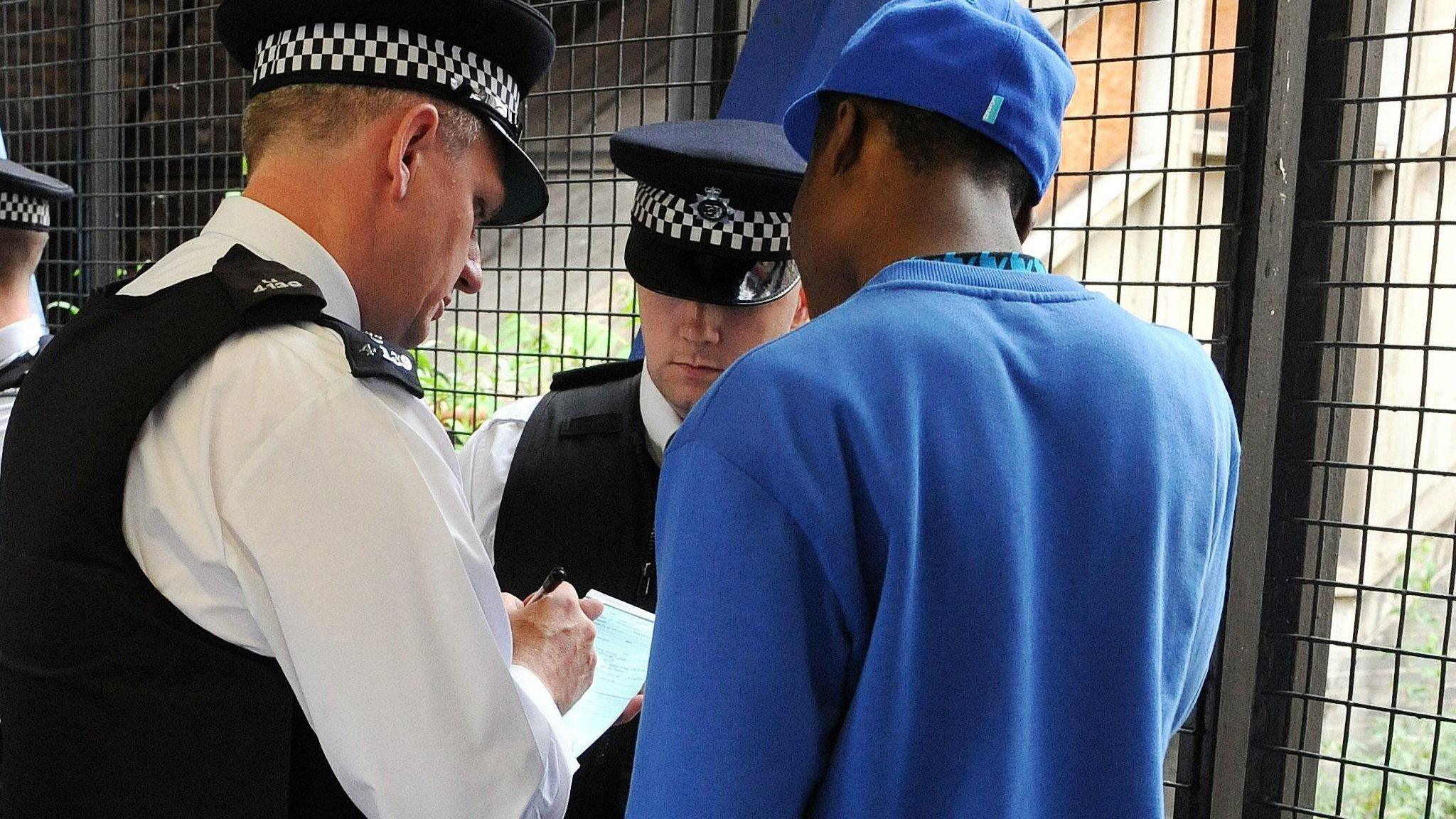 Police officers conduct a stop and search