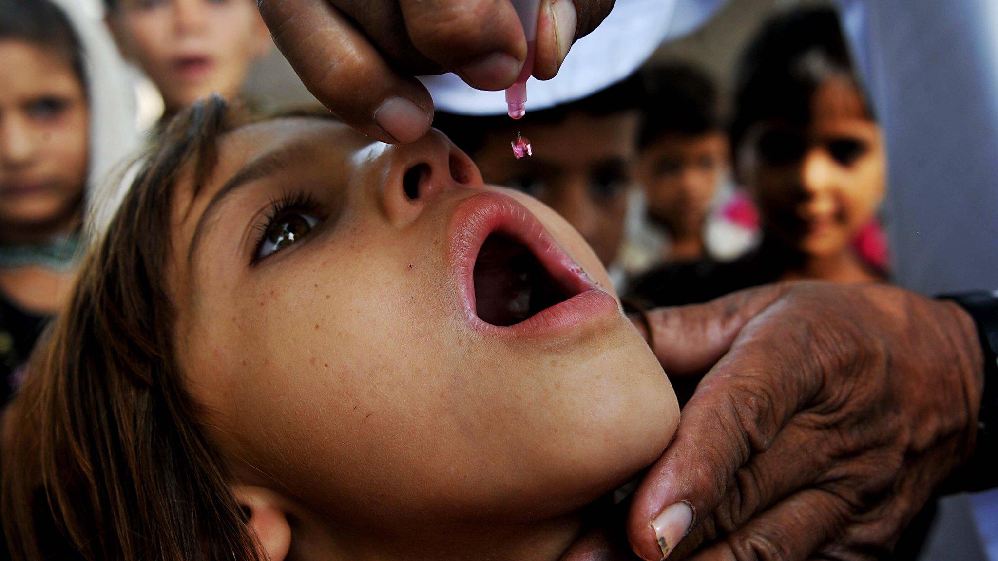 Girl getting polio vaccine