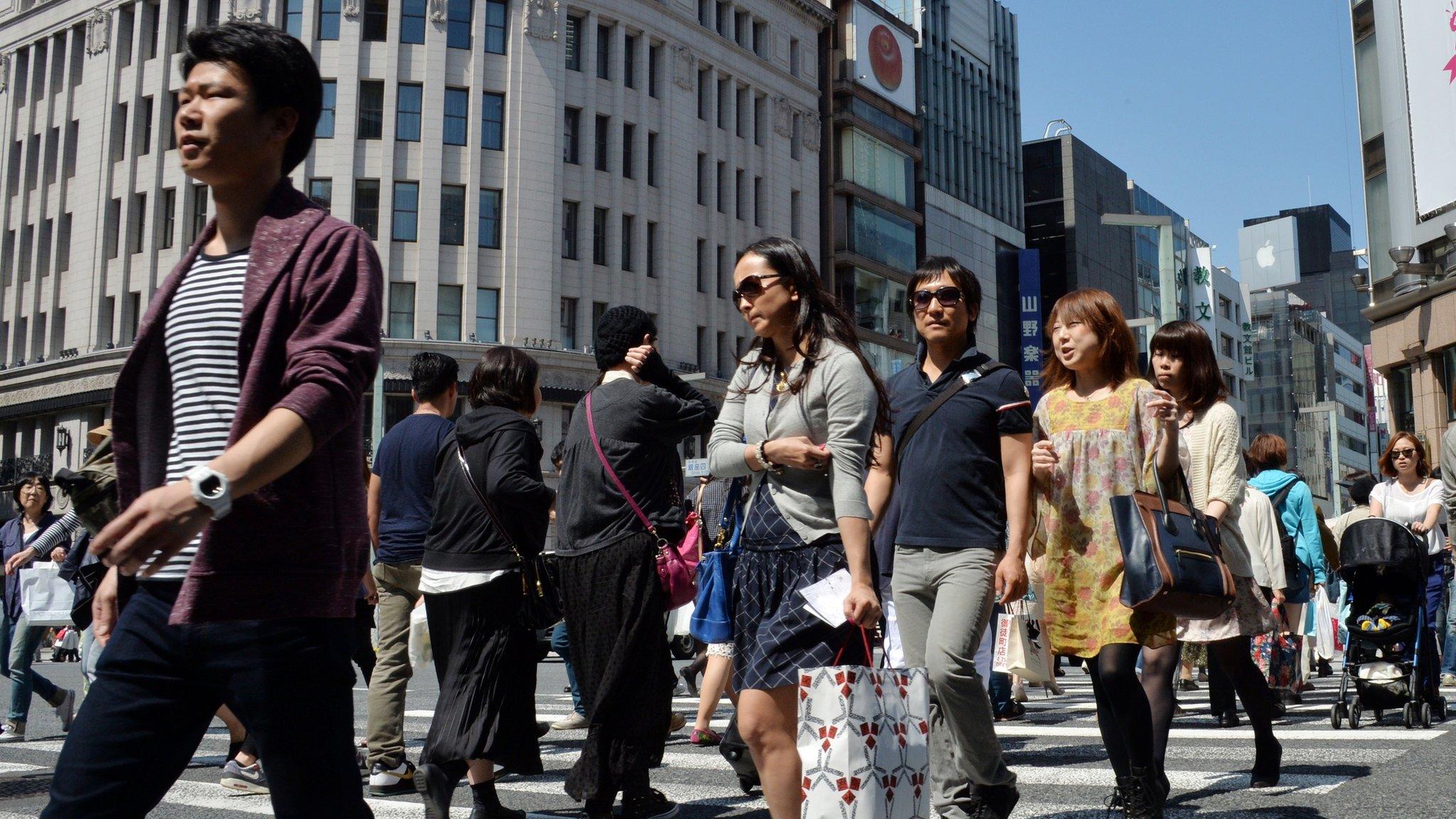 Pedestrians walk in Tokyo's Ginza shopping district