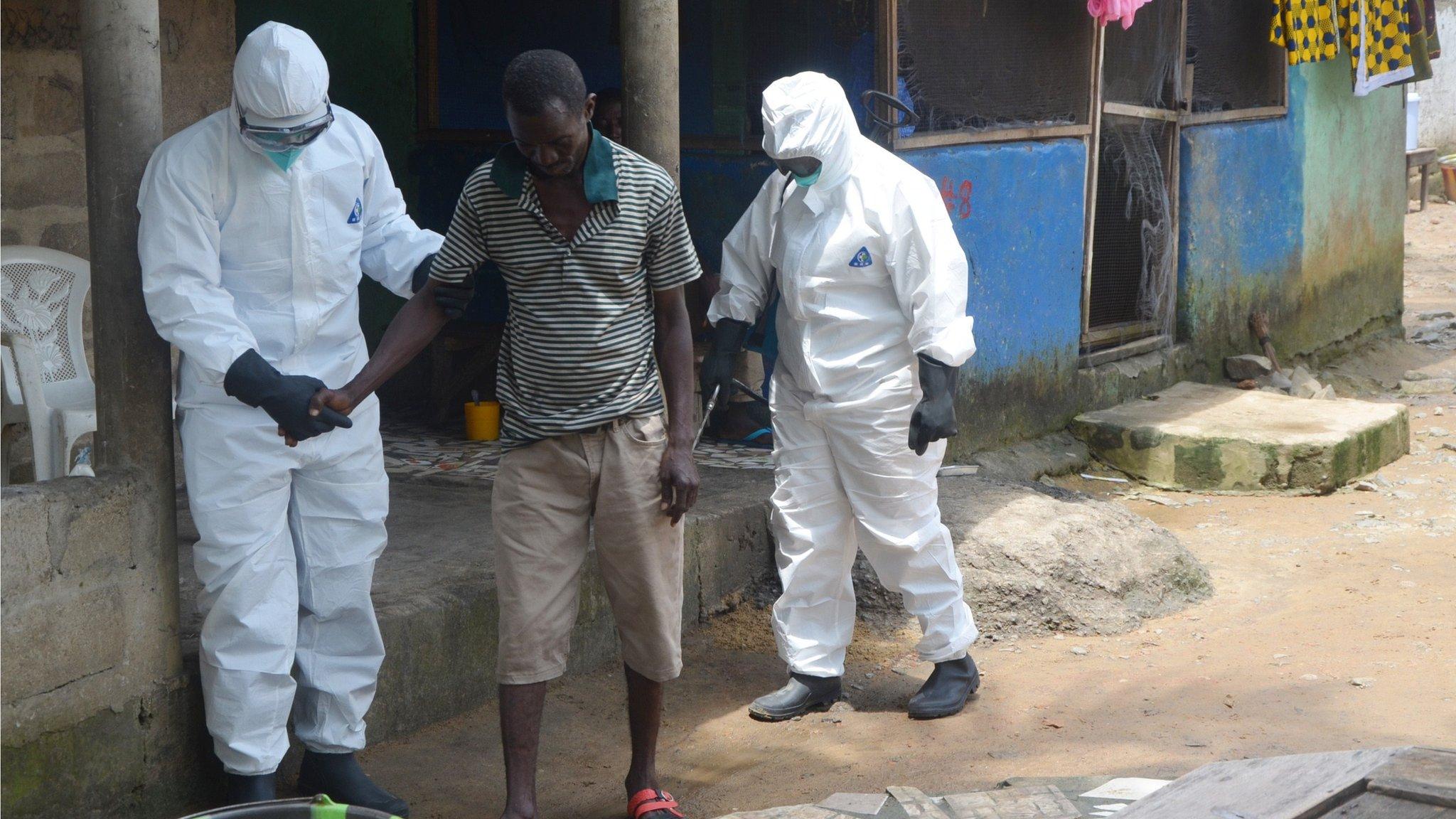 Nurses helping man with Ebola