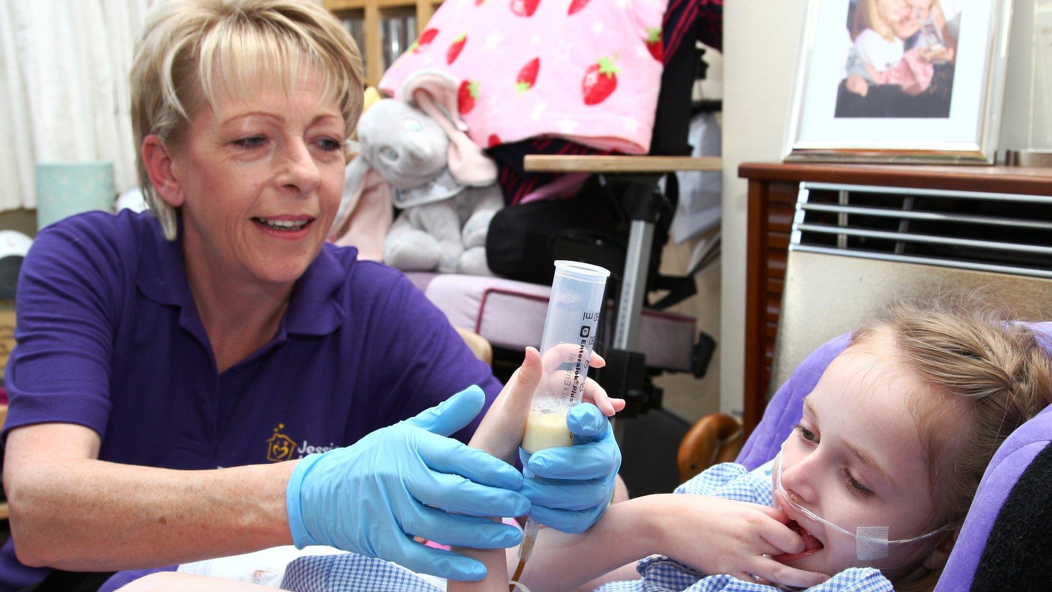 Jessie May nurse treating a young patient