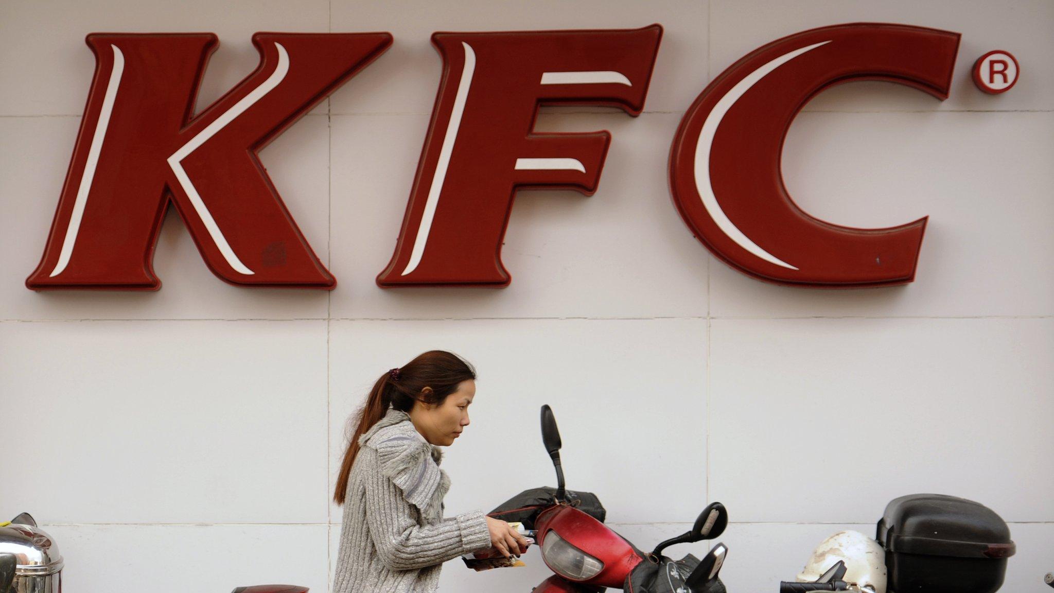 A woman in China outside a KFC store