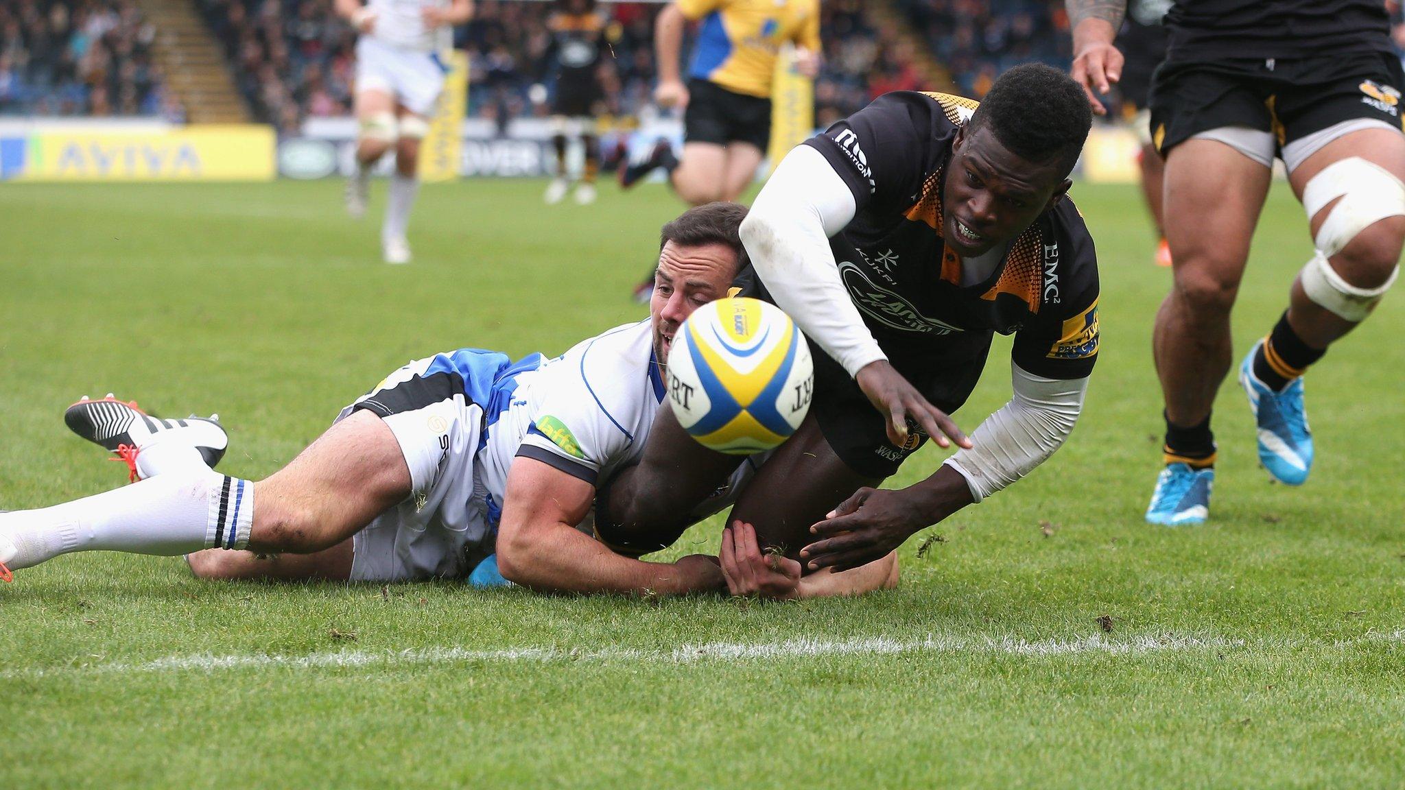 Christian Wade of Wasps is tackled without the ball short of the try line by Micky Young