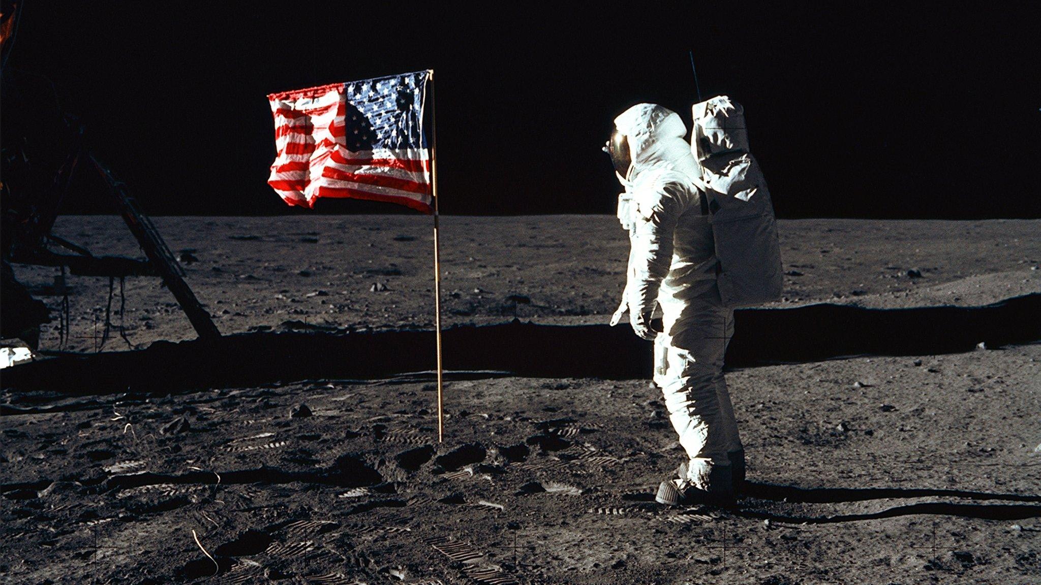 Caption:376713 03: (FILE PHOTO) Astronaut Edwin E. Aldrin, Jr., the lunar module pilot of the first lunar landing mission, stands next to a United States flag July 20, 1969 during an Apollo 11 Extravehicular Activity (EVA) on the surface of the Moon. The 30th anniversary of Apollo's moon landing is celebrated July 20, 1999. (Photo by NASA/Newsmakers)