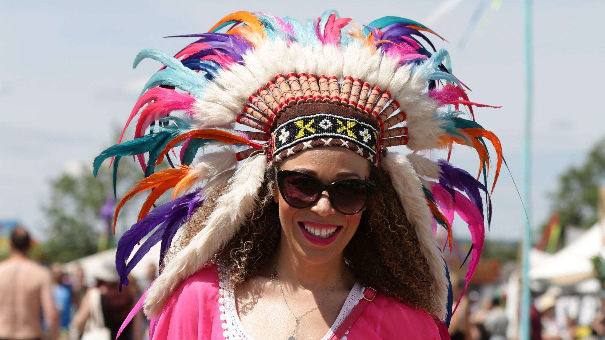 Glastonbury festival-goer in native american head dress