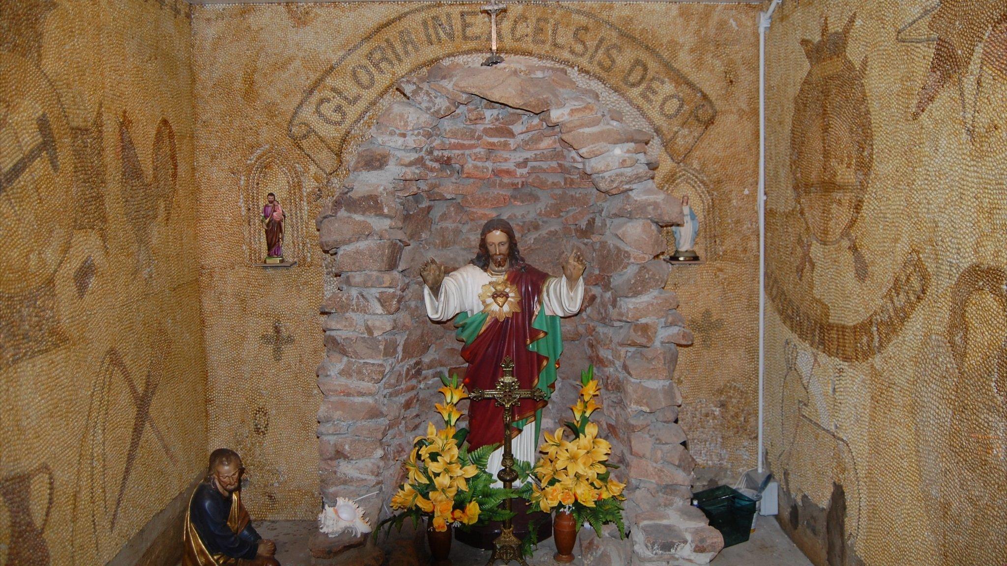 Statues and shells inside Le Galloudec shell shrine at Fort Hommet, Guernsey