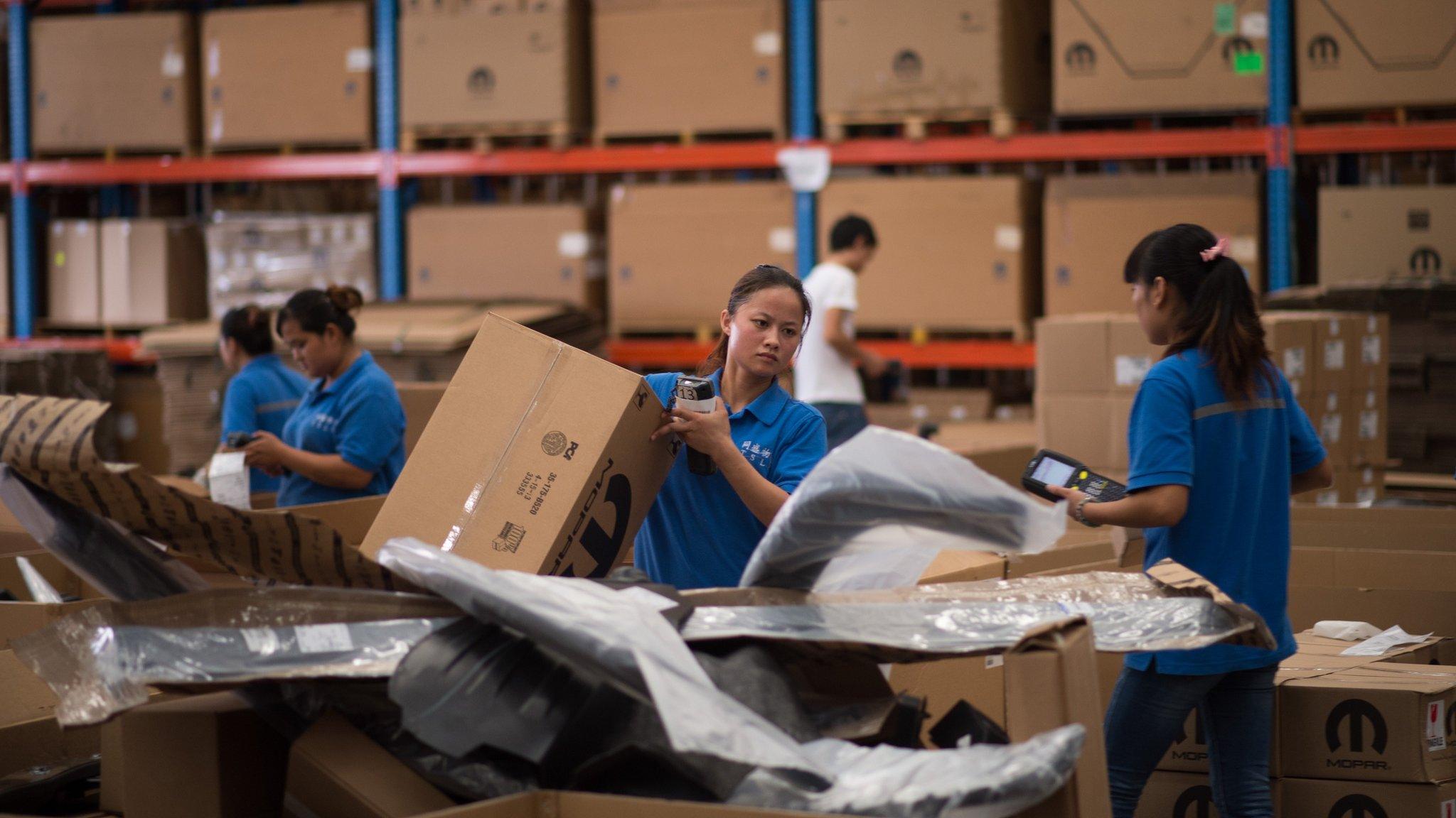 Chinese workers packing goods at a warehouse in the Shanghai Pilot Free Trade zone