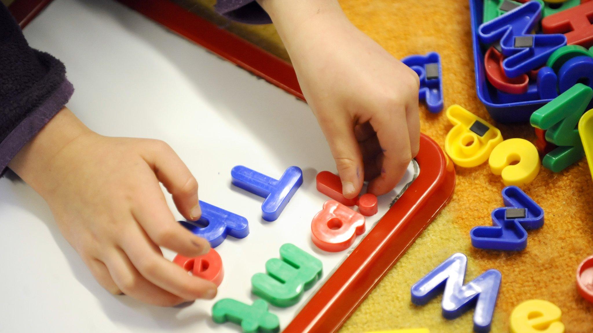 Child playing with letters