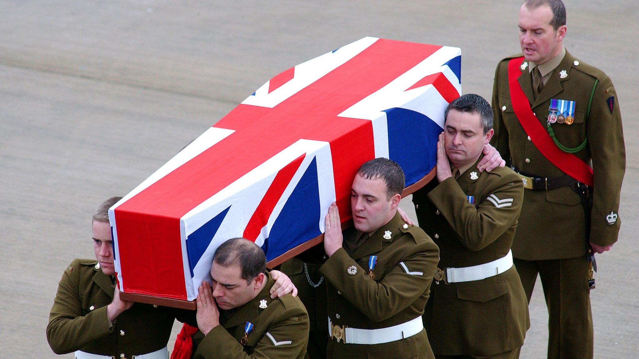 The Union Jack draped coffin of Private Jonathan Peter Kitulagoda is carried off the Royal Air Force Hercules upon its arrival on February 5, 2004 at the Royal Air Force Brize Norton, England. 23-year-old private Kitulagoda was killed by a suspected suicide bomb attack near a military base on January 28, 2004 in Kabul, Afghanistan