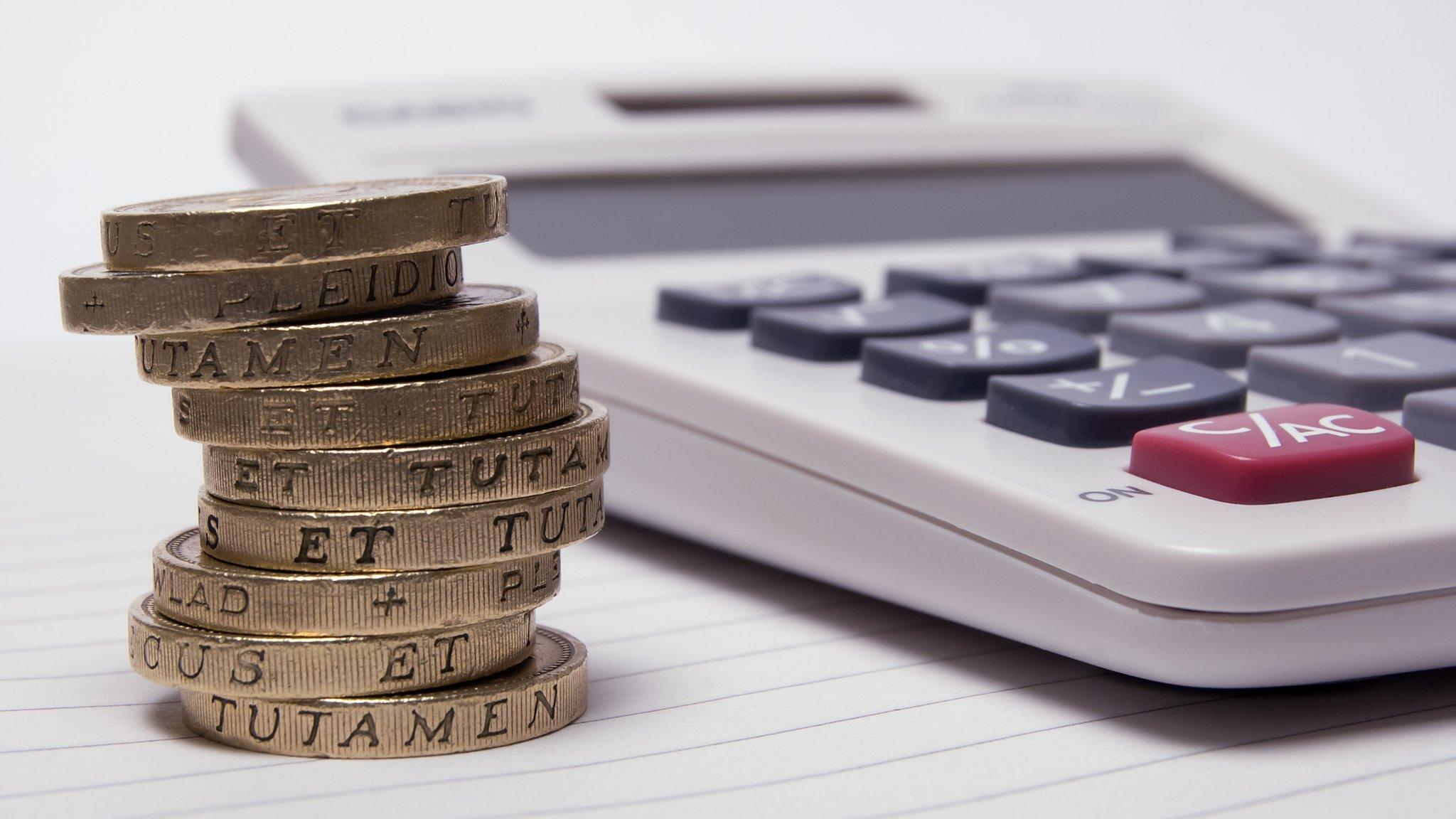 Calculator and pile of pound coins