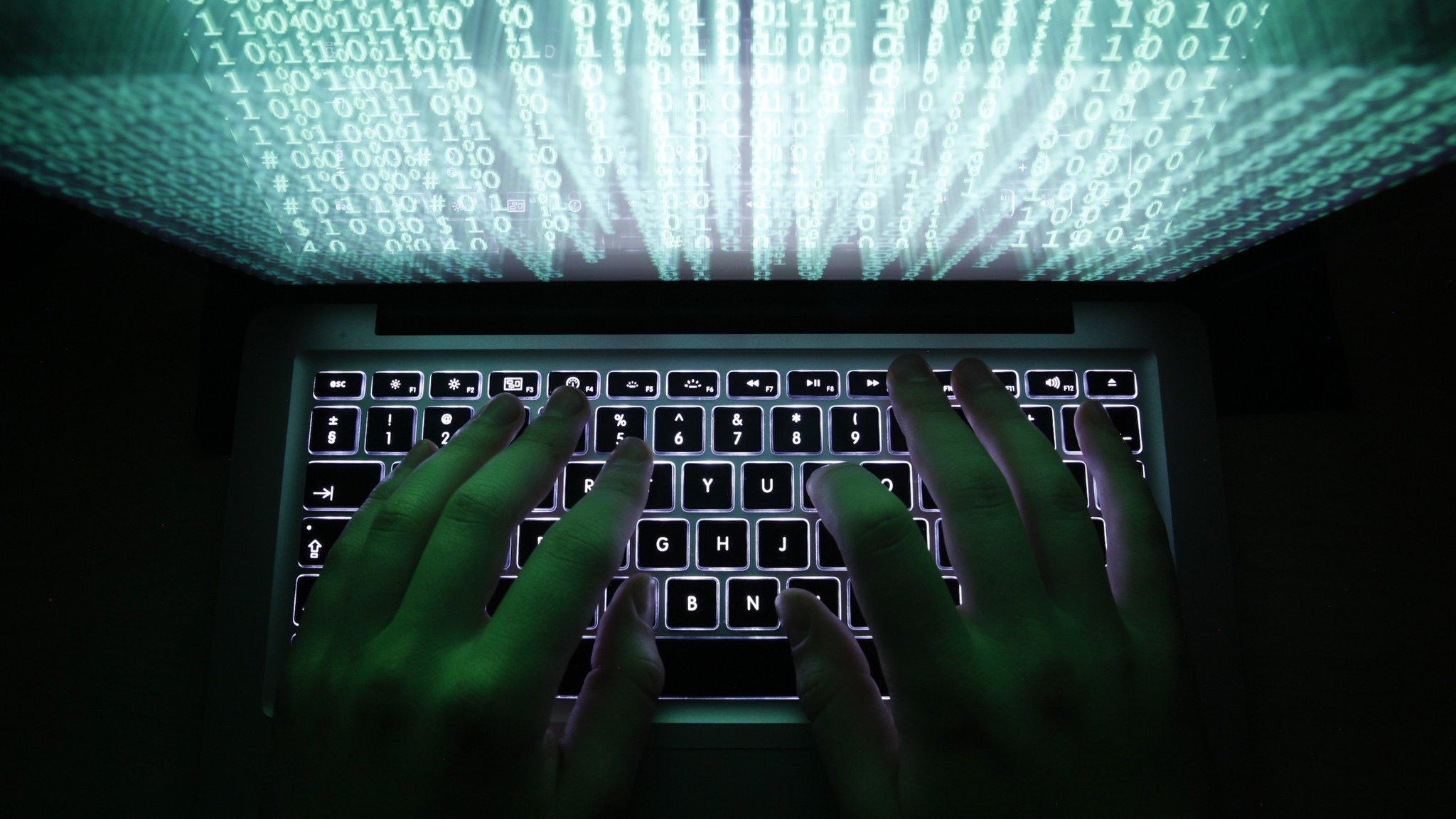 Man typing on computer keyboard