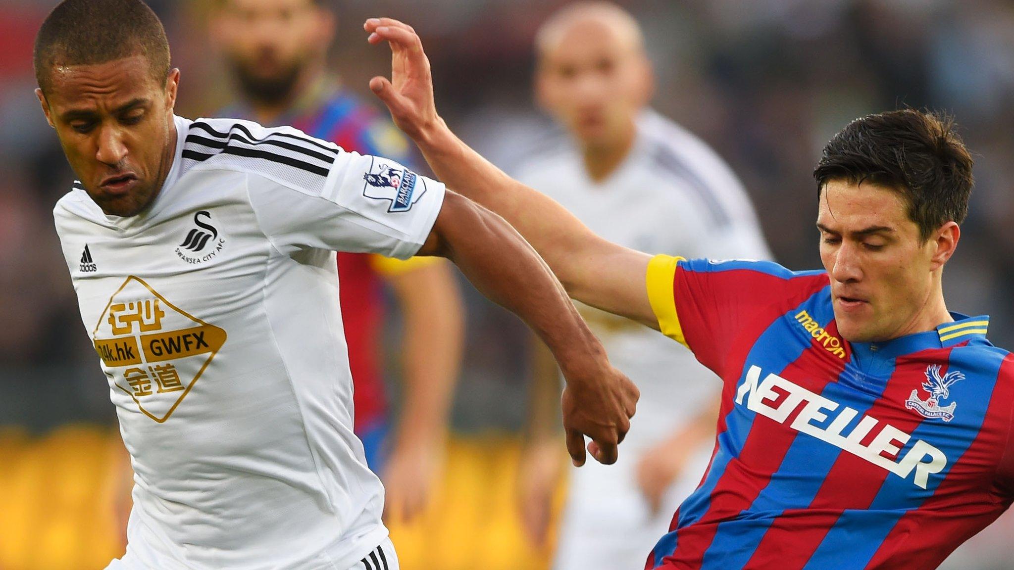 Wayne Routledge and Martin Kelly battle for possession