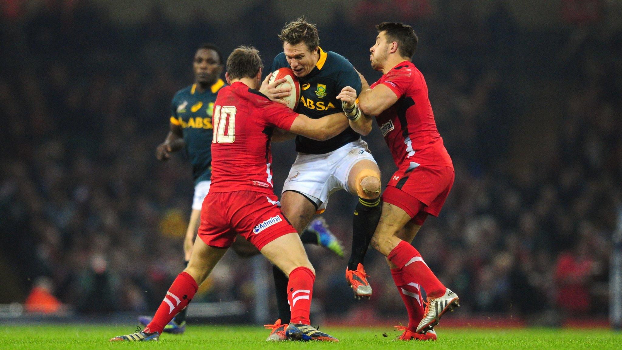 Wales players Dan Biggar and Rhys Webb tackle Jean de Villiers of South Africa during the Autumn international match between Wales and South Africa