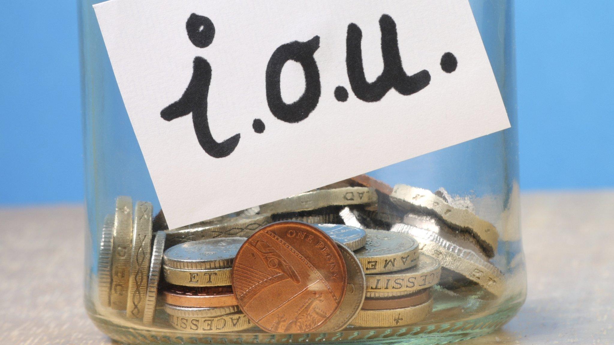 Jar of coins with iou written on it