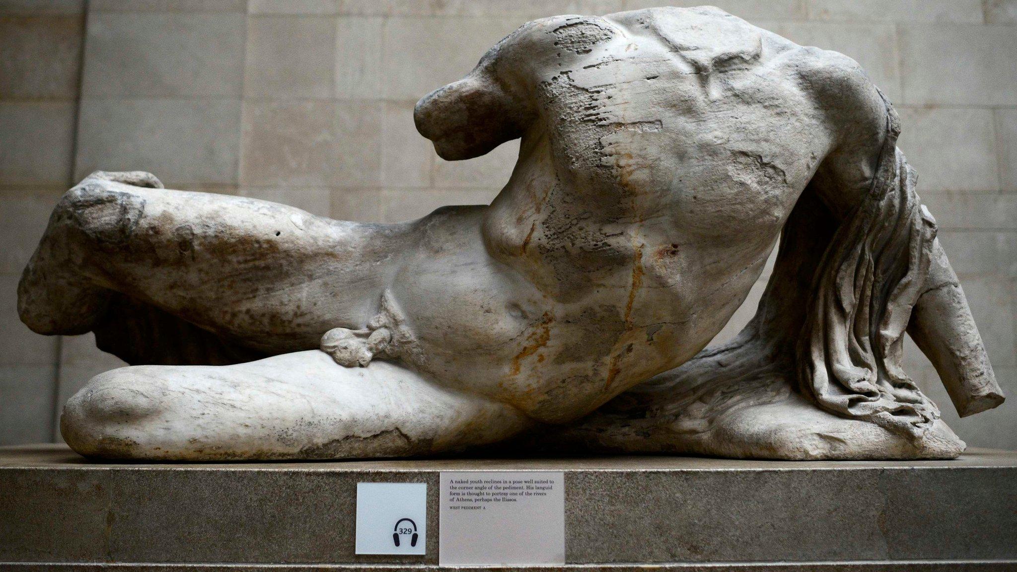 A naked, headless statue, part of a collection of stone objects, inscriptions and sculptures, known as the Elgin Marbles on display in the British Museum