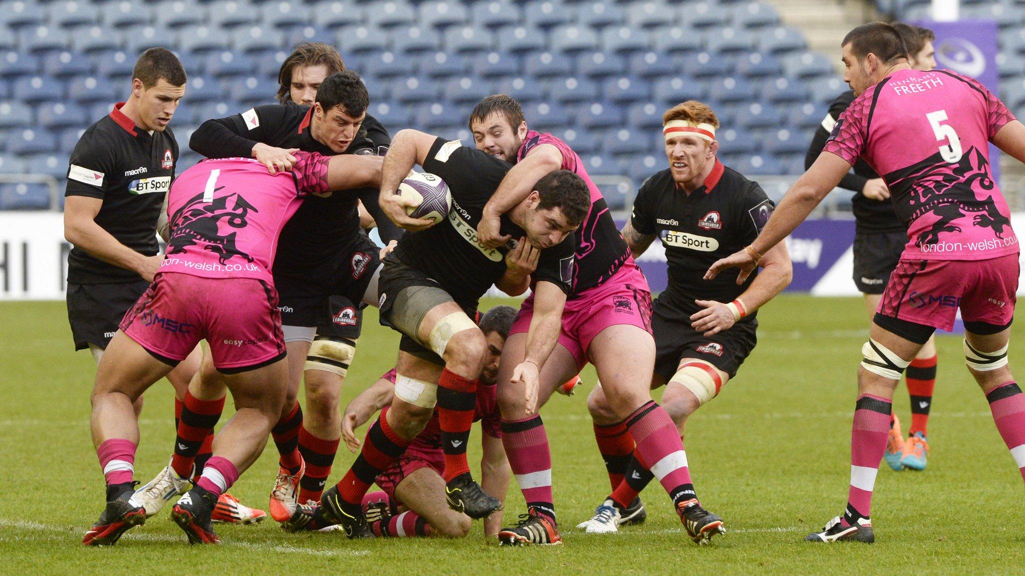 Edinburgh's Nick McLennan (centre) is tackled by Ben Cooper