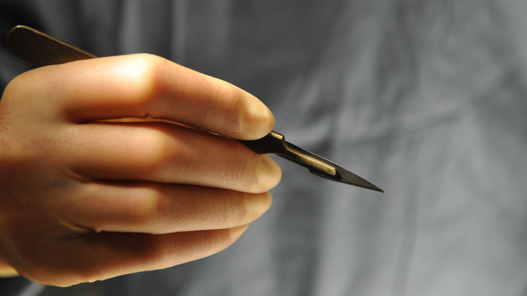 Surgeon holding a scalpel