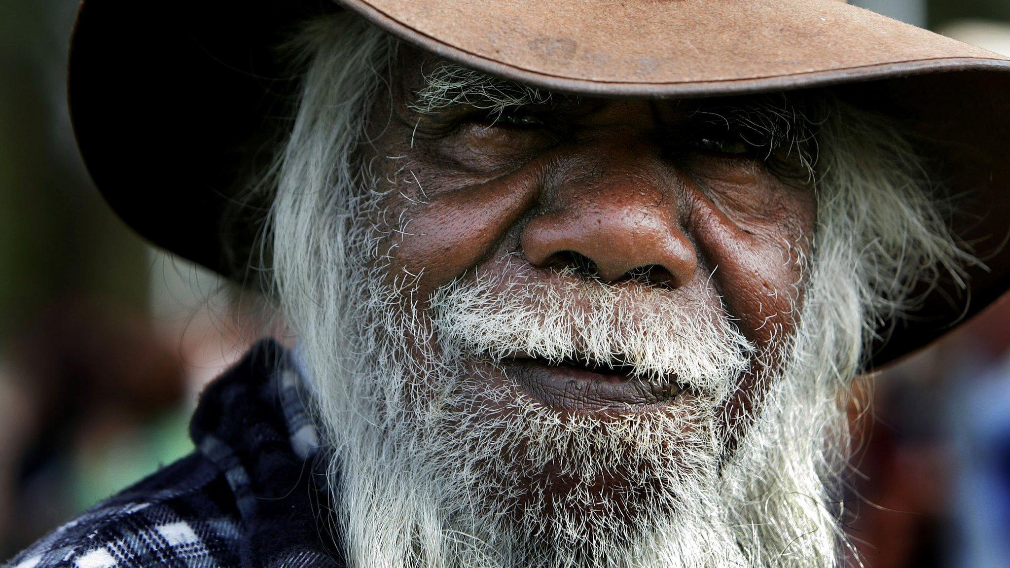 An indigenous Australian arrives to hear Australian Prime Minister Kevin Rudd deliver an apology to the Aboriginal people for injustices committed over two centuries of white settlement at the Australian Parliament on 13 February 2008 in Canberra, Australia