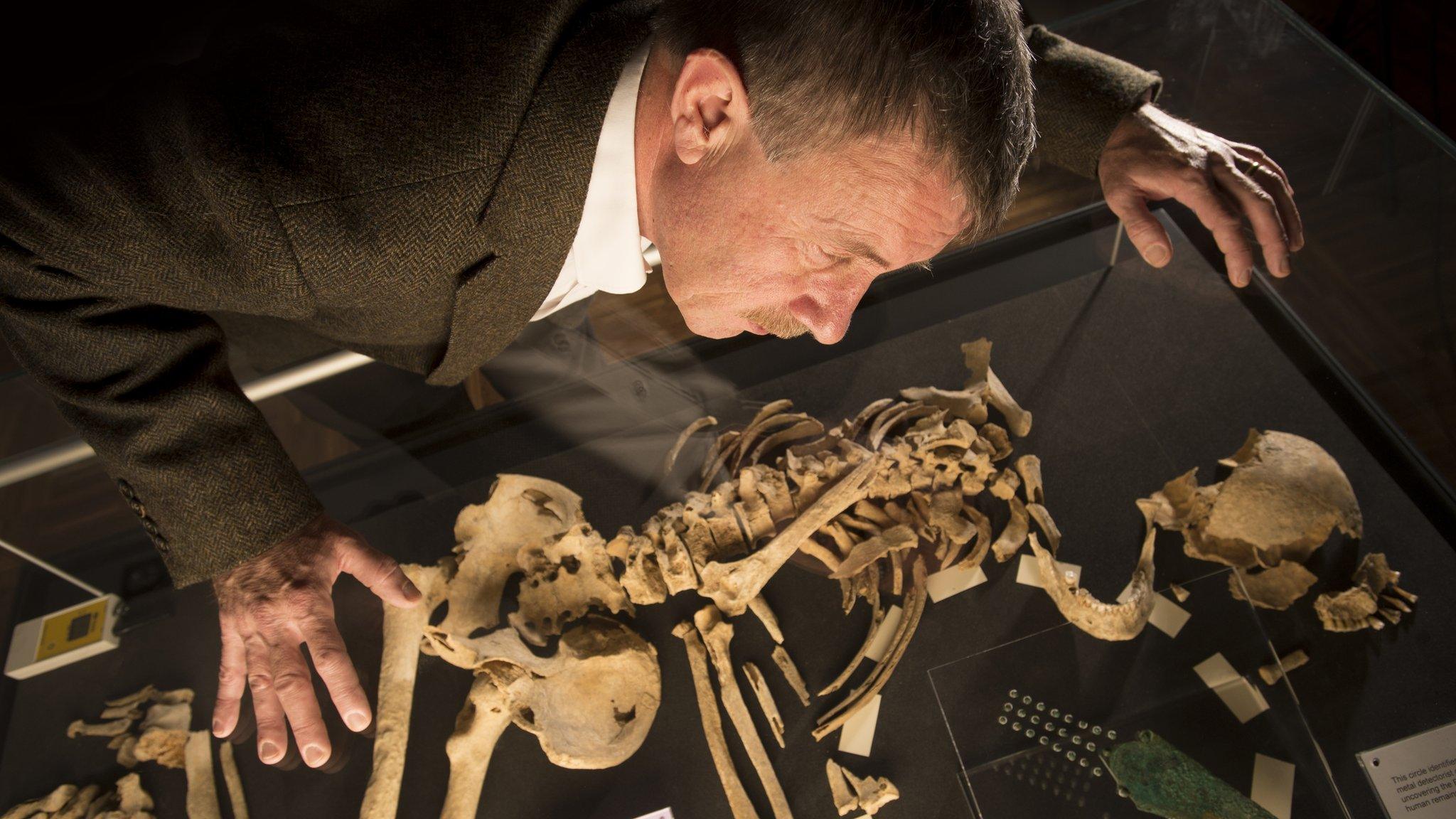 Man studying Racton Man skeleton