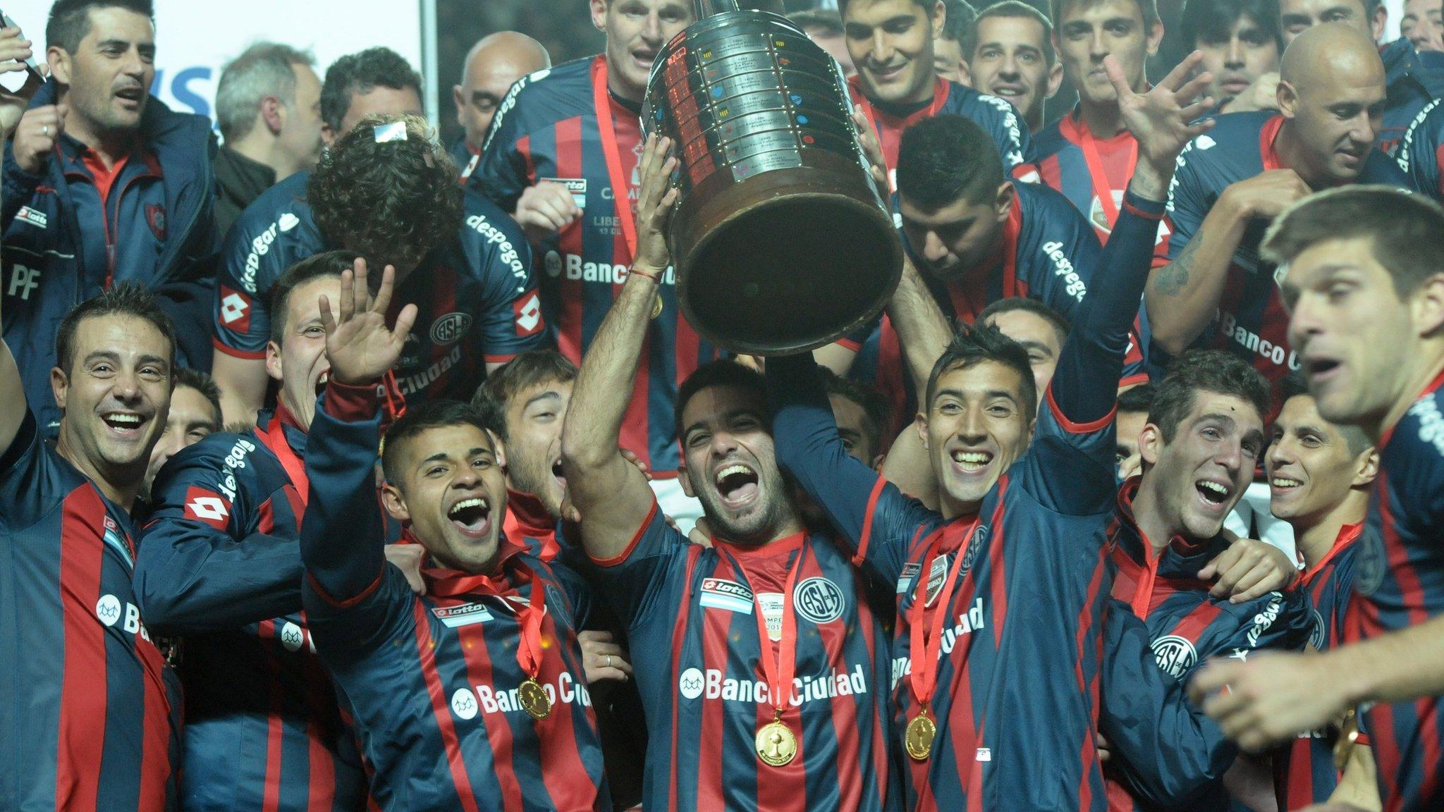 Argentina's San Lorenzo players hold up the Copa Libertadores