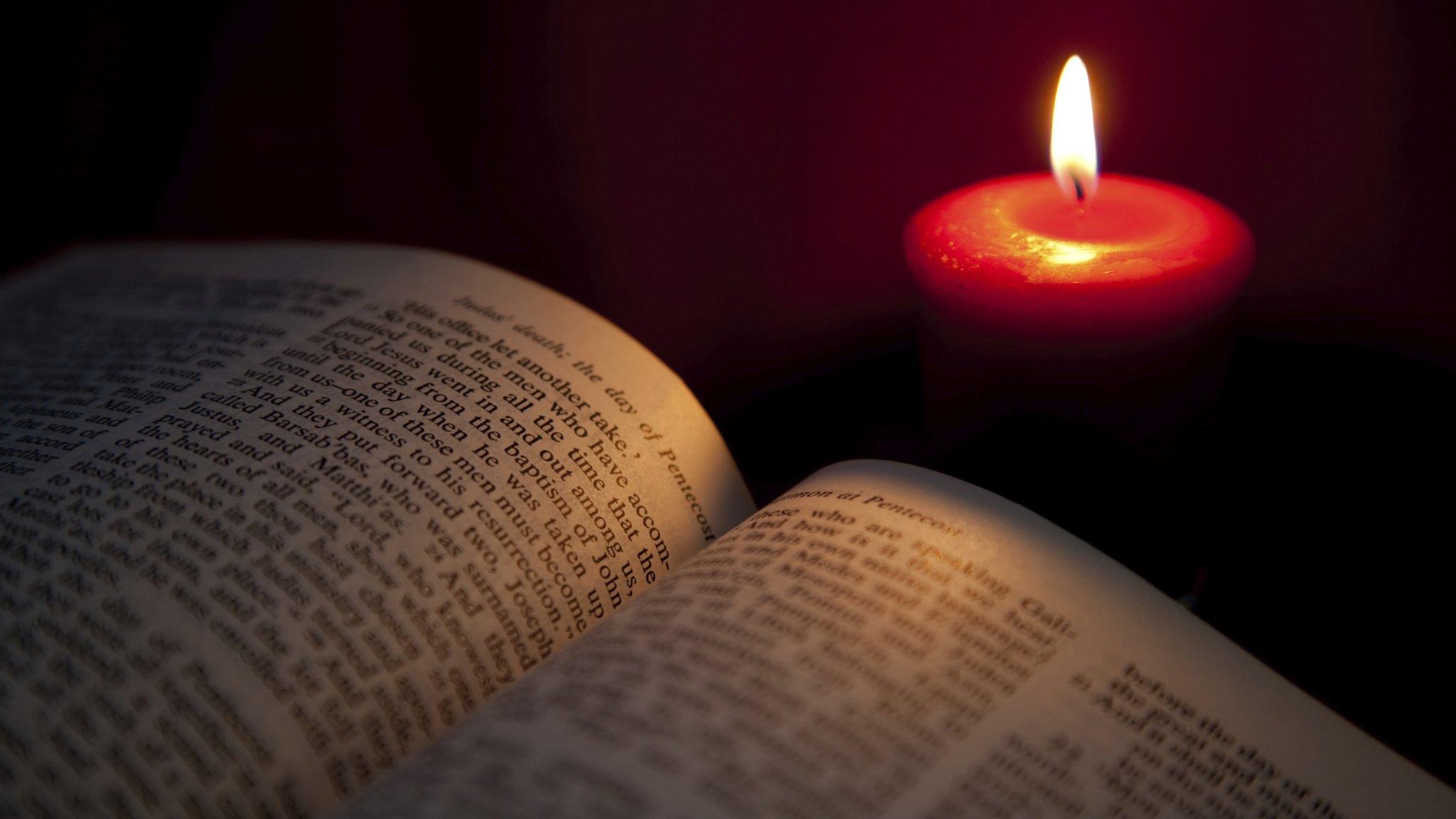 Open bible and candle