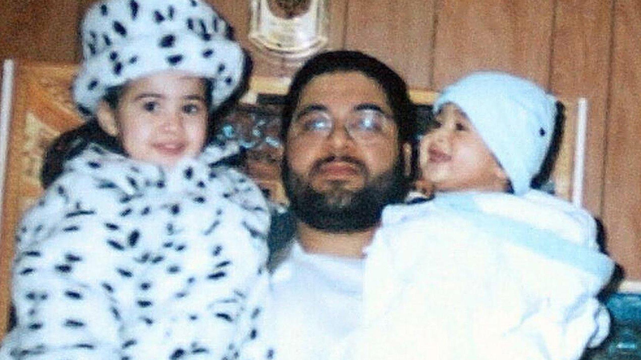 Shaker Aamer holding two of his children