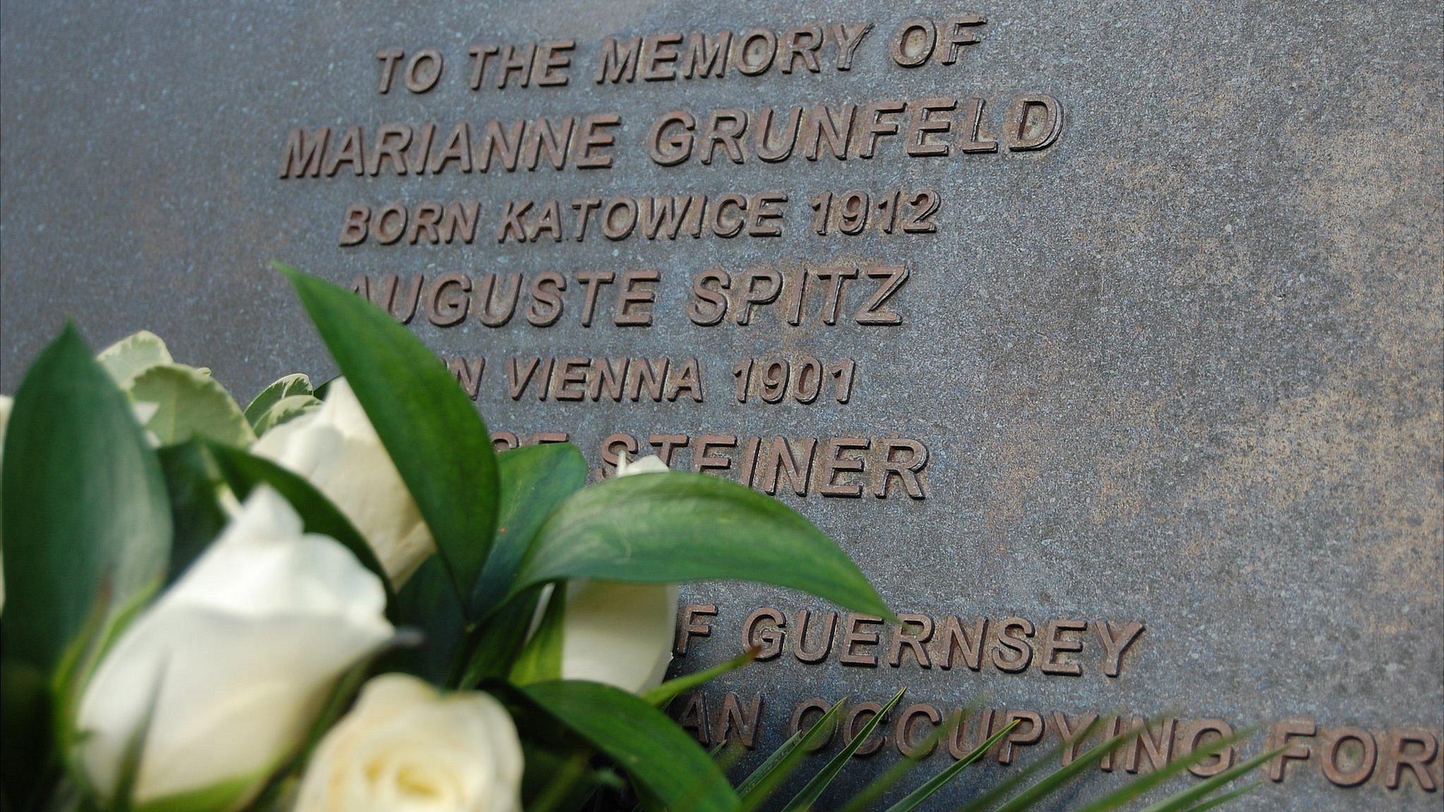 Flowers laid at Guernsey memorial for three Jewish women deported from the island during the German occupation in World War 2. Later all three died in Auschwitz