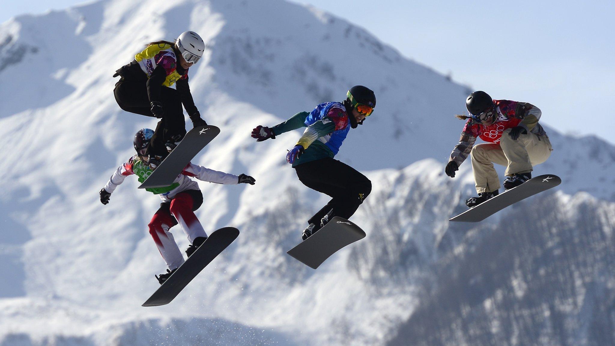 Snowboarders race in snowboard cross competiton