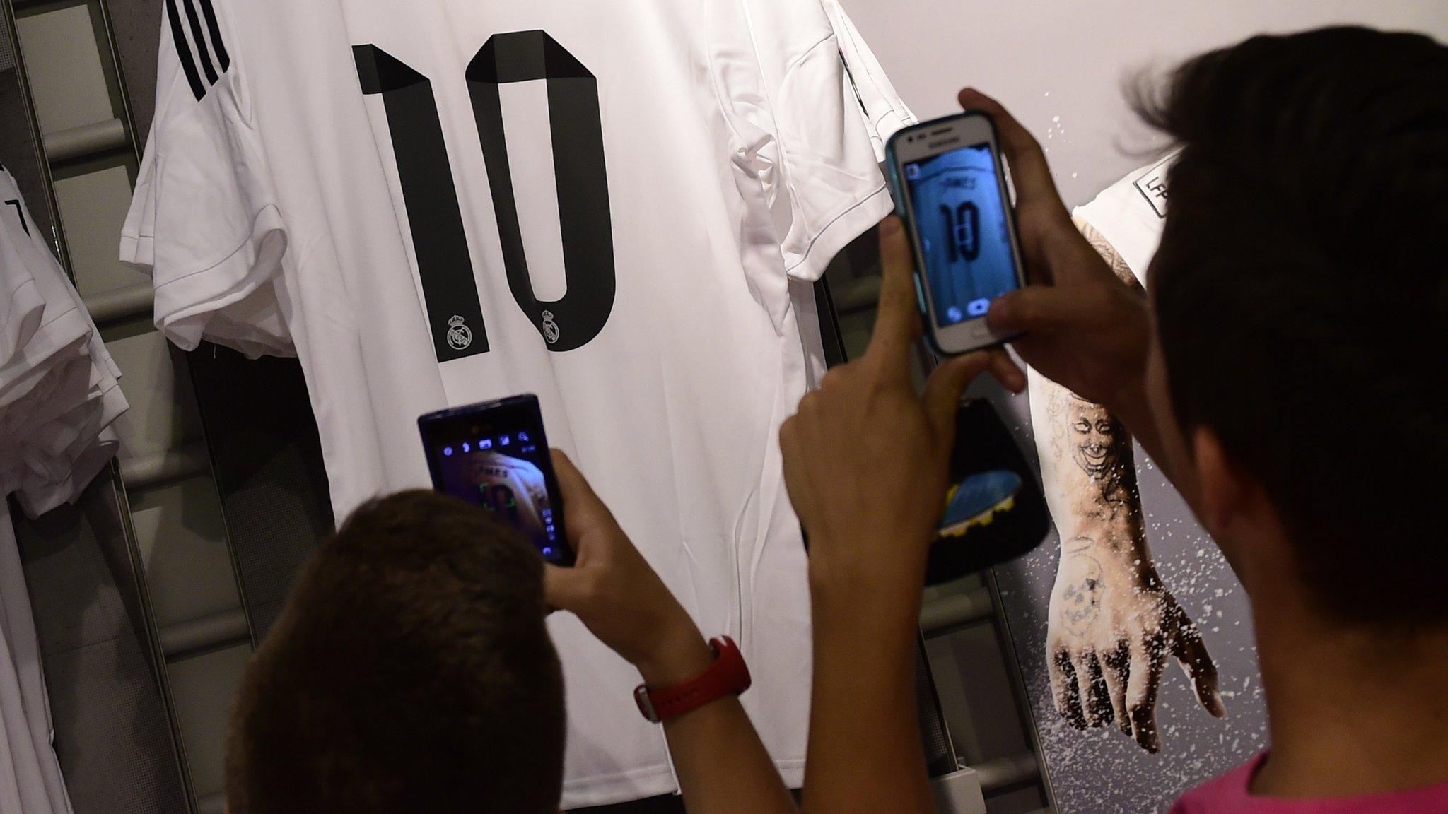 Fans taking pictures of new signing's shirt